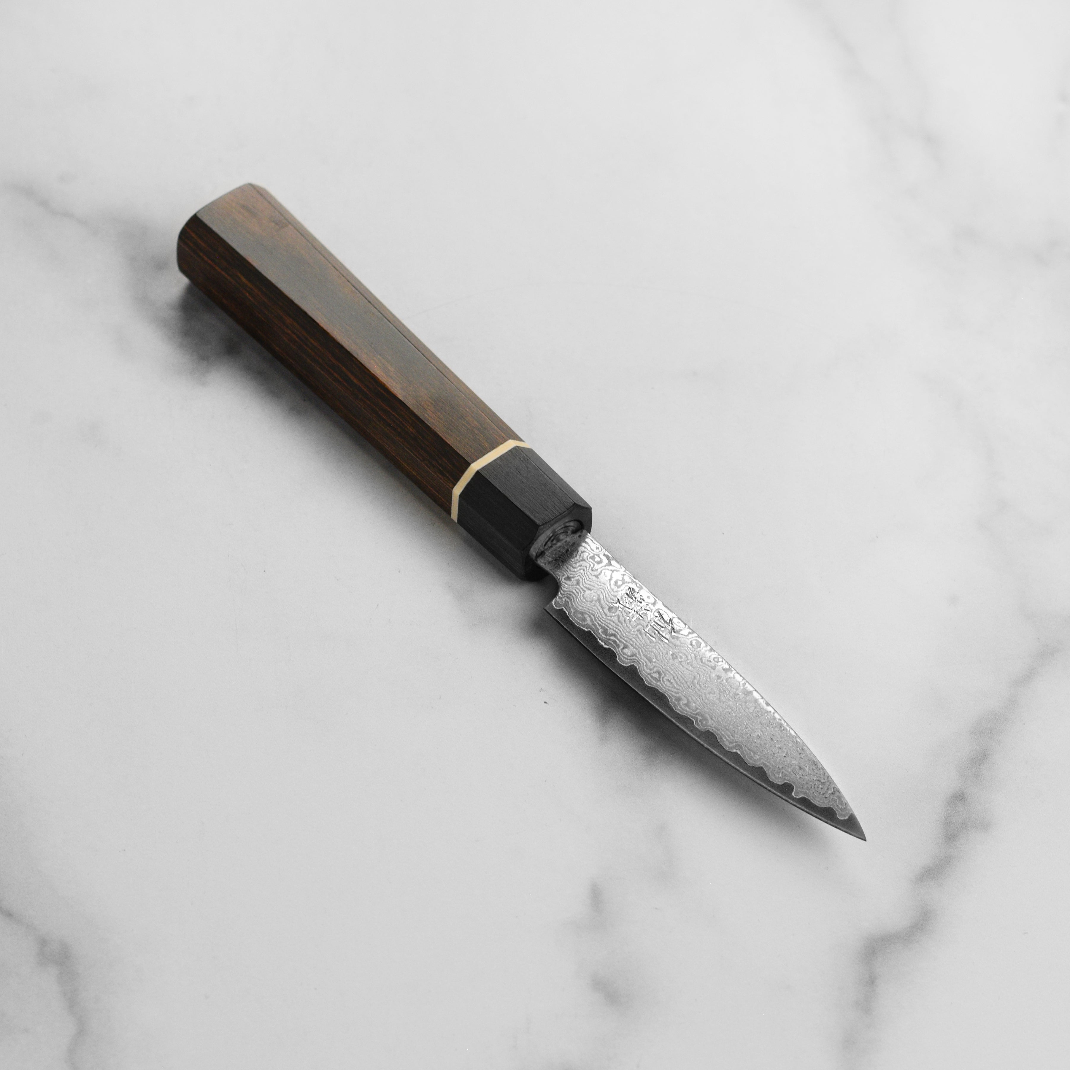 Close-up of the Senzo Elite VG10 Damascus paring knife blade highlighting its intricate design.