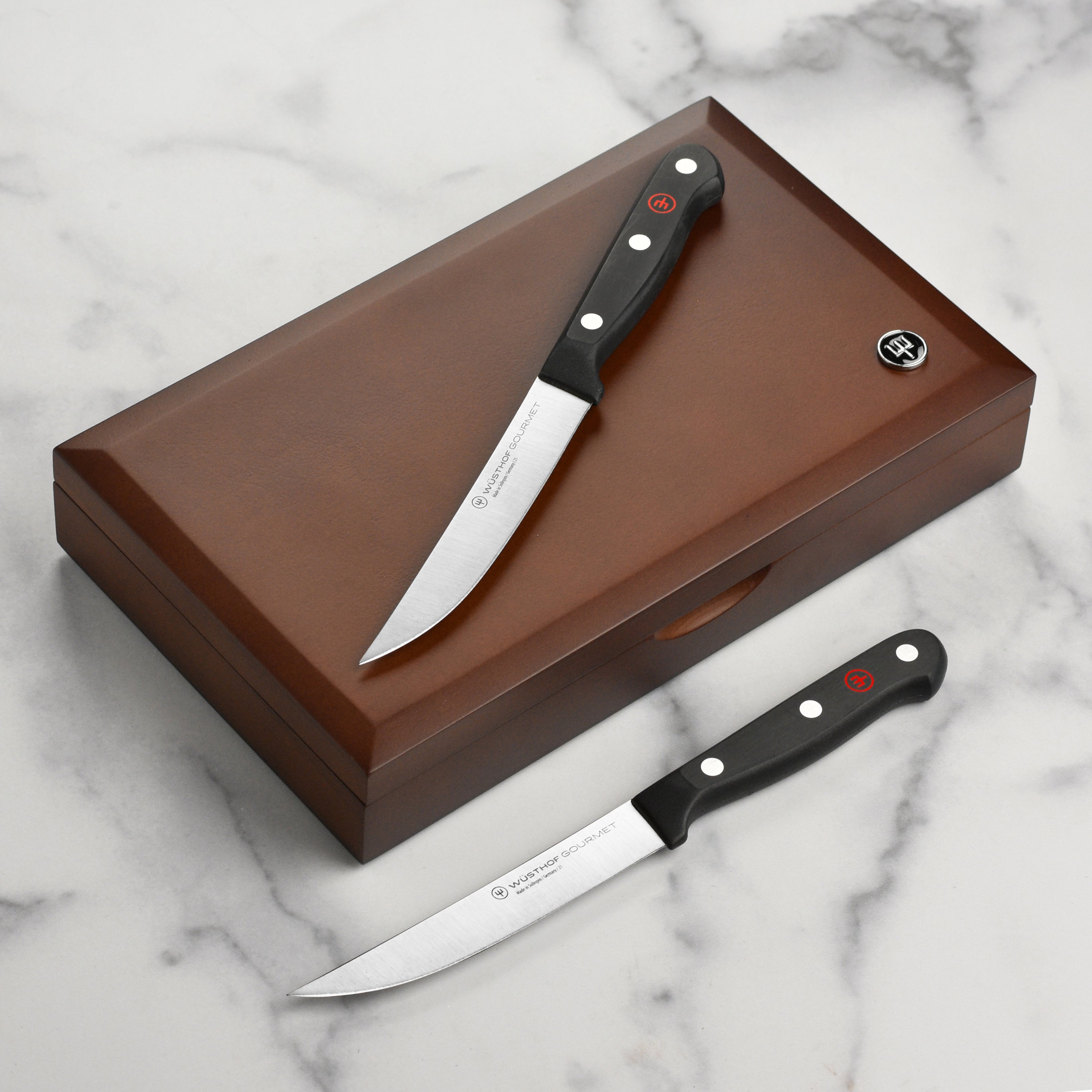 Close-up of Wusthof gourmet steak knives highlighting the precision blade and ergonomic handle.
