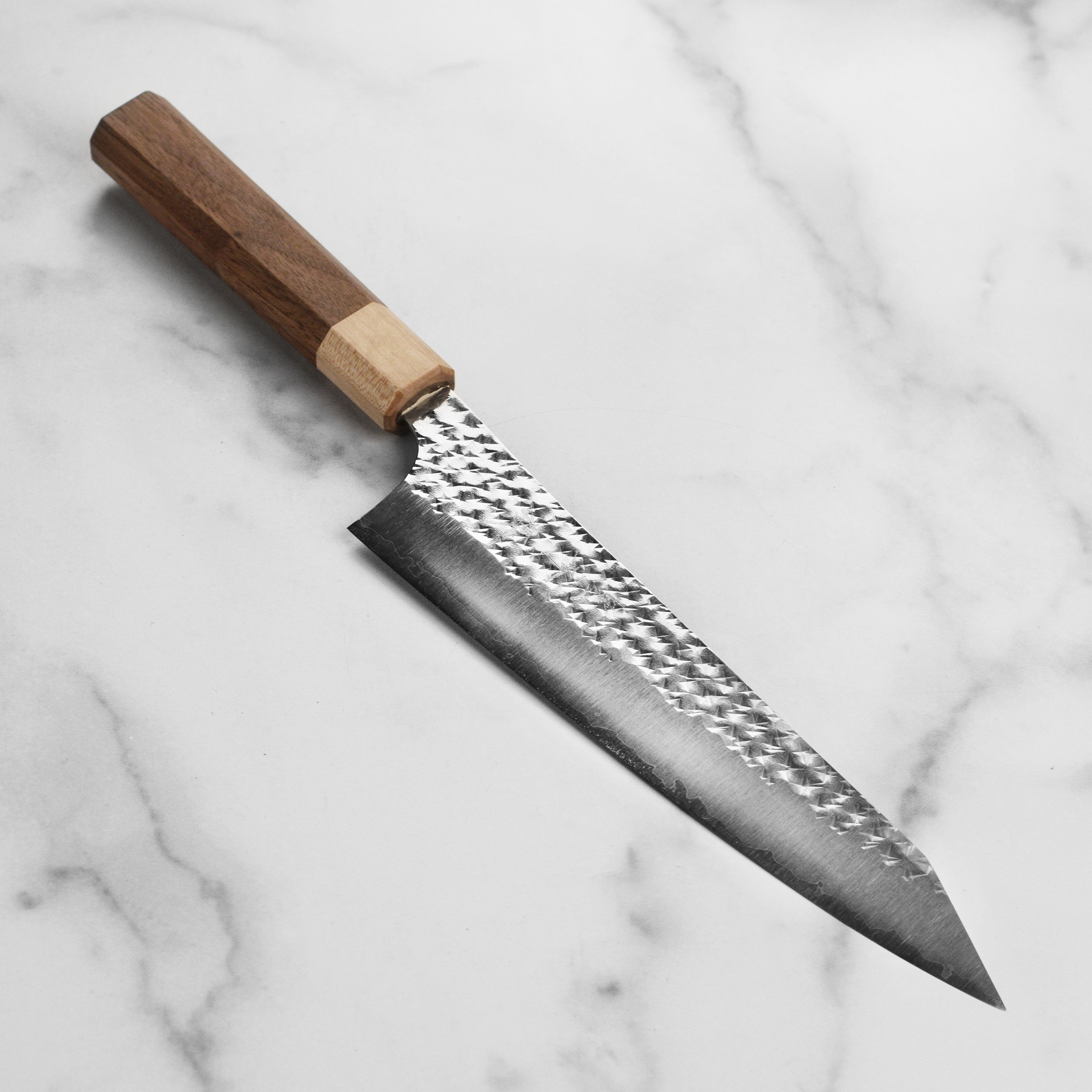 Kurosaki Senko Ei SG2 Gyuto Knife showcasing its polished blade and textured surface.
