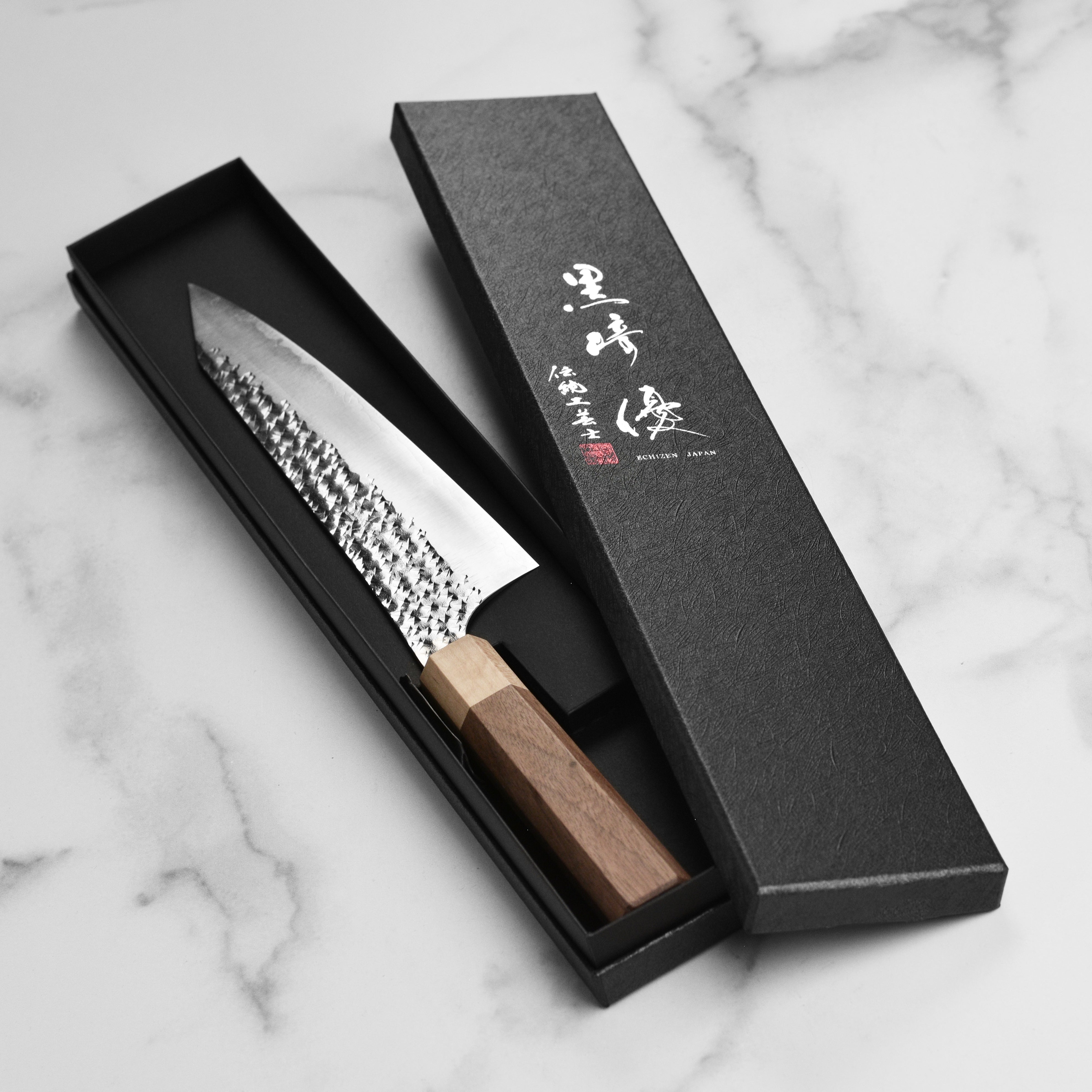 Kurosaki Senko Ei Gyuto knife in a kitchen setting, ideal for professional chefs.