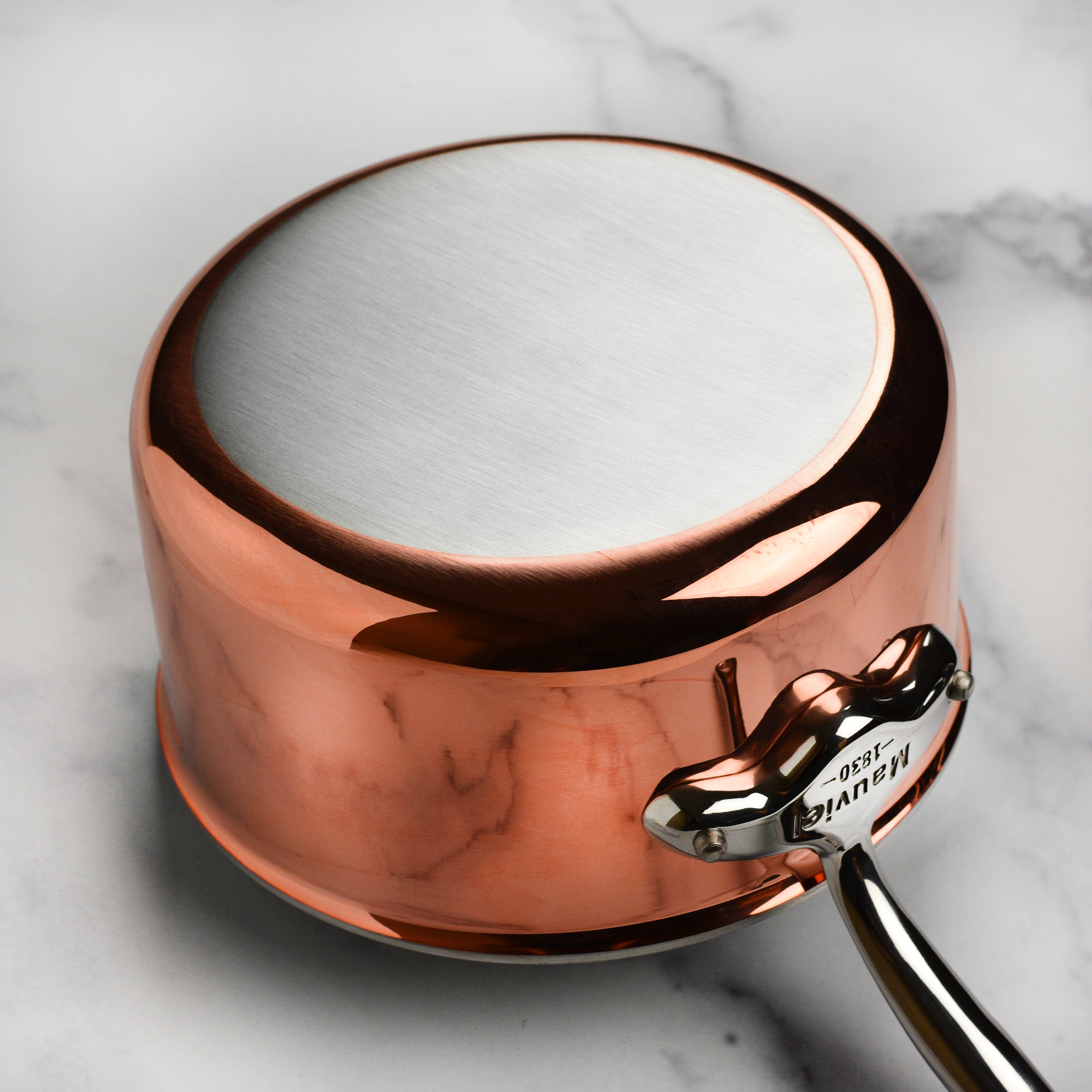 Elegant copper saucepan with cast stainless steel handle and lid