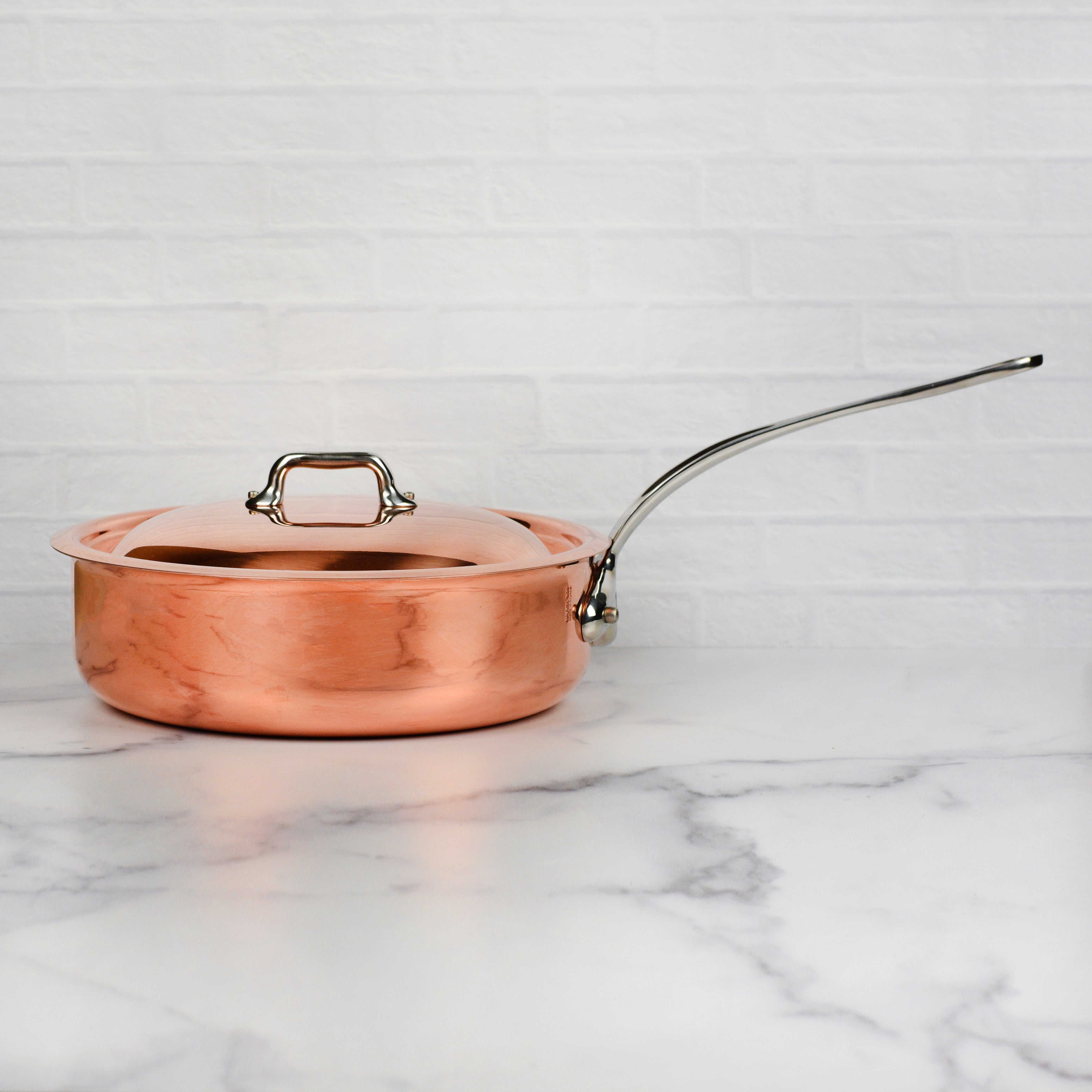 Chef sautéing vegetables in Mauviel M6S copper pan on induction cooktop