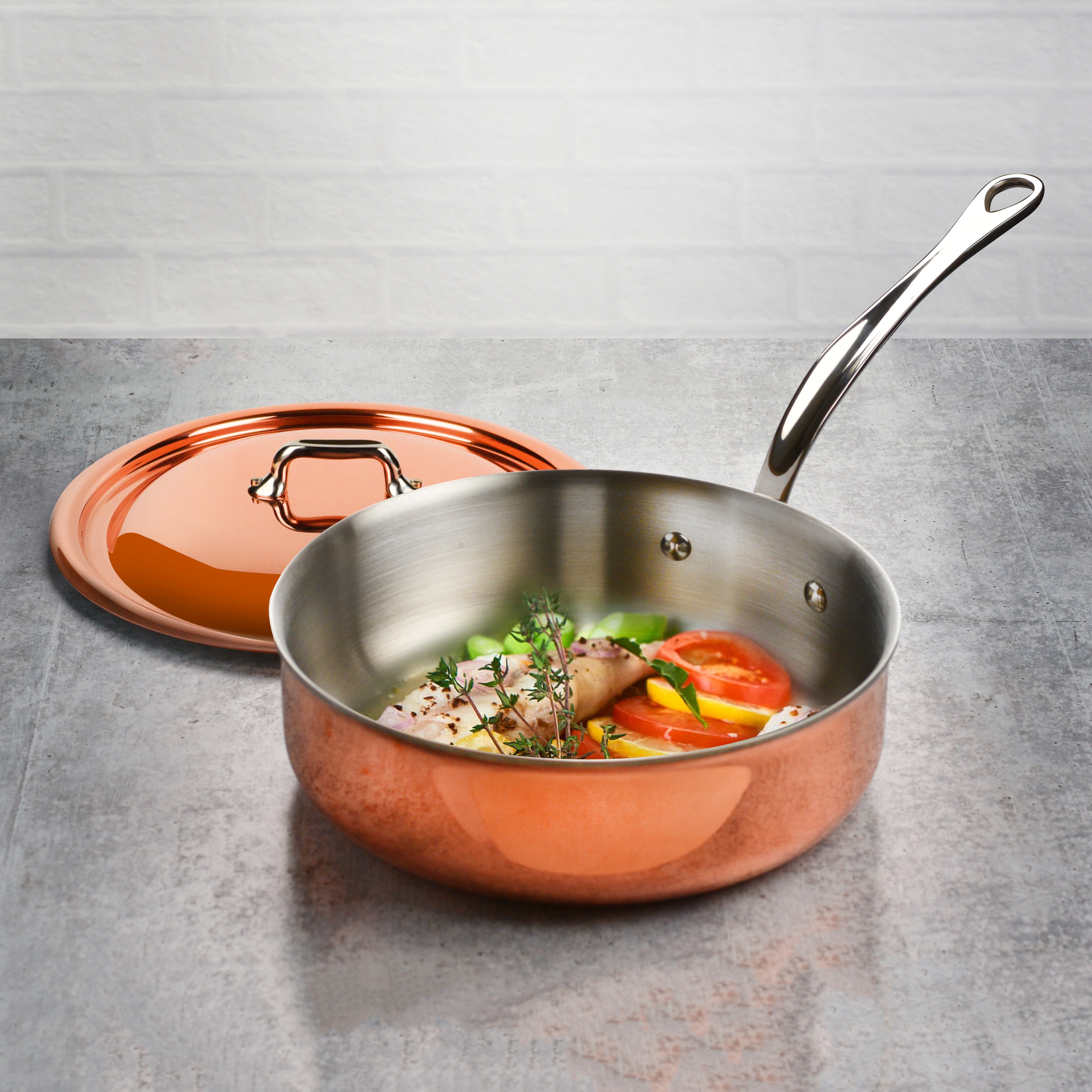 Chef sautéing vegetables in Mauviel M6S copper pan on induction cooktop