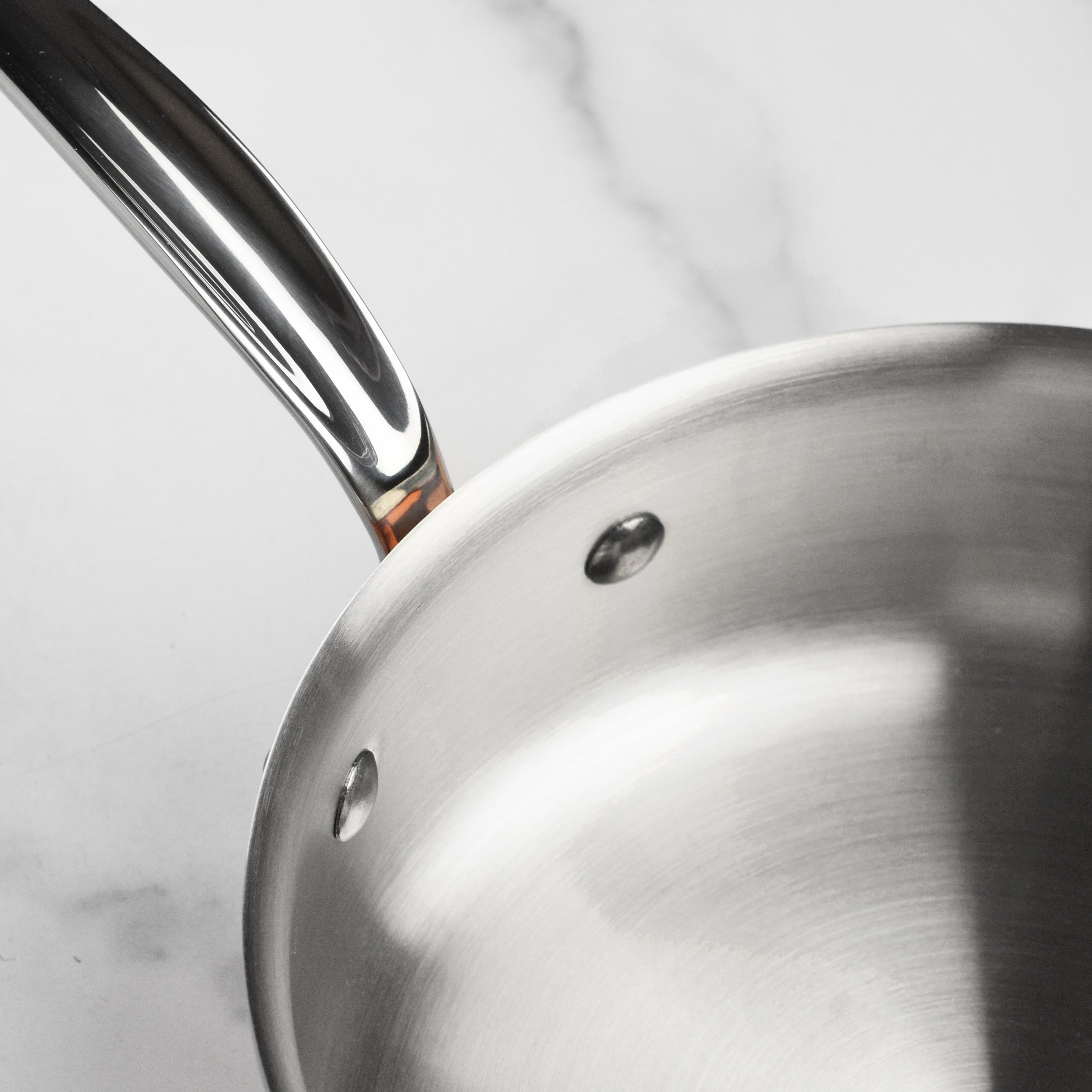 Mauviel M6S copper saute pan with lid, highlighting its elegant finish and sturdy handle.