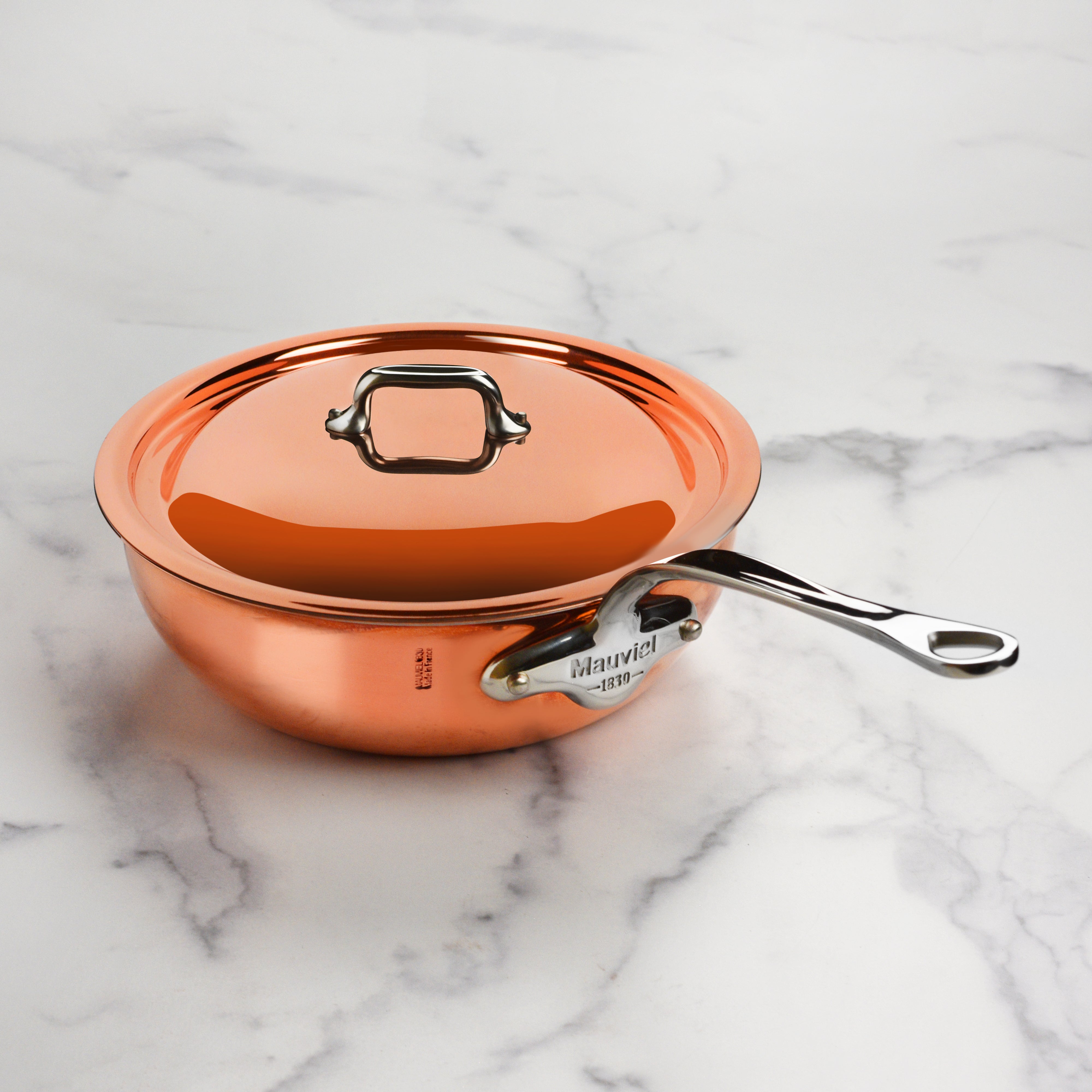 Close-up view of the copper sauté pans stainless steel rivets and finish.