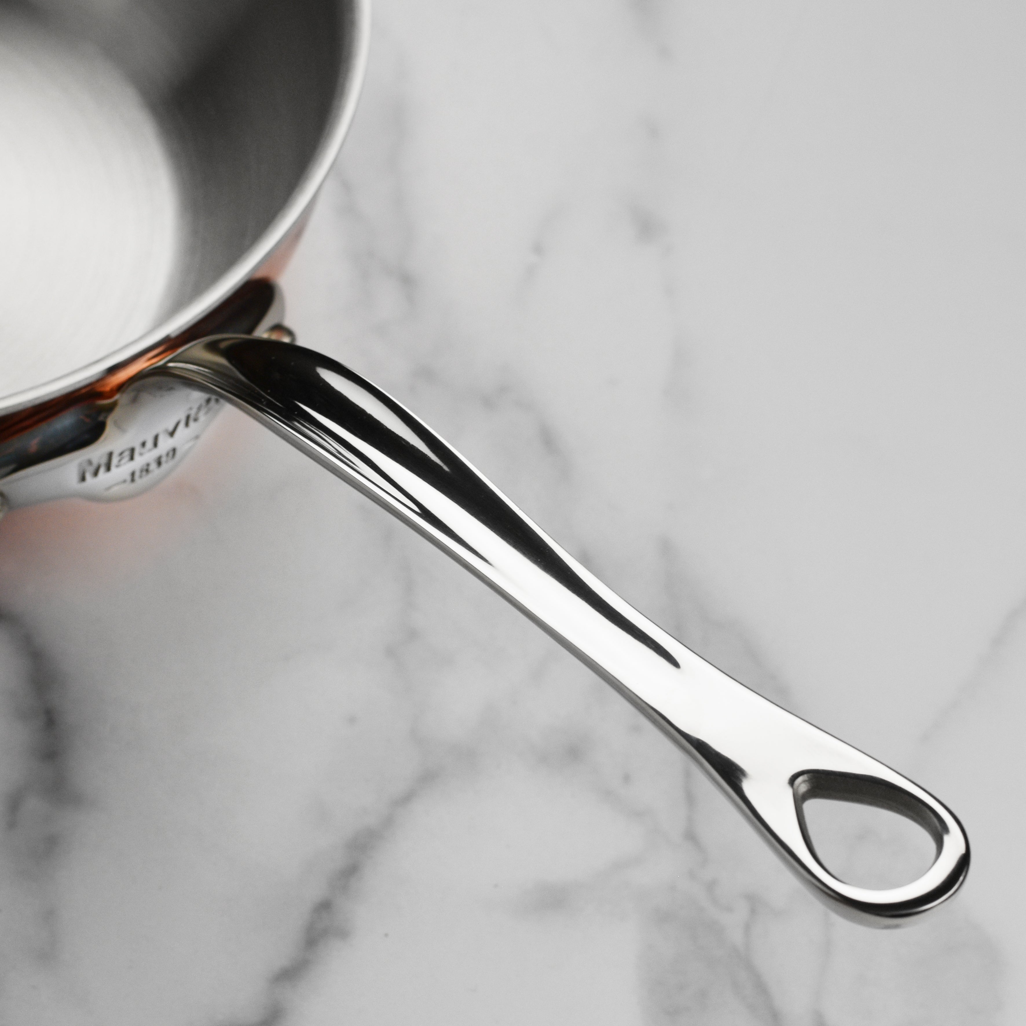 Mauviel M6S 3.4-quart copper sauté pan showcasing its elegant design and sturdy handle.