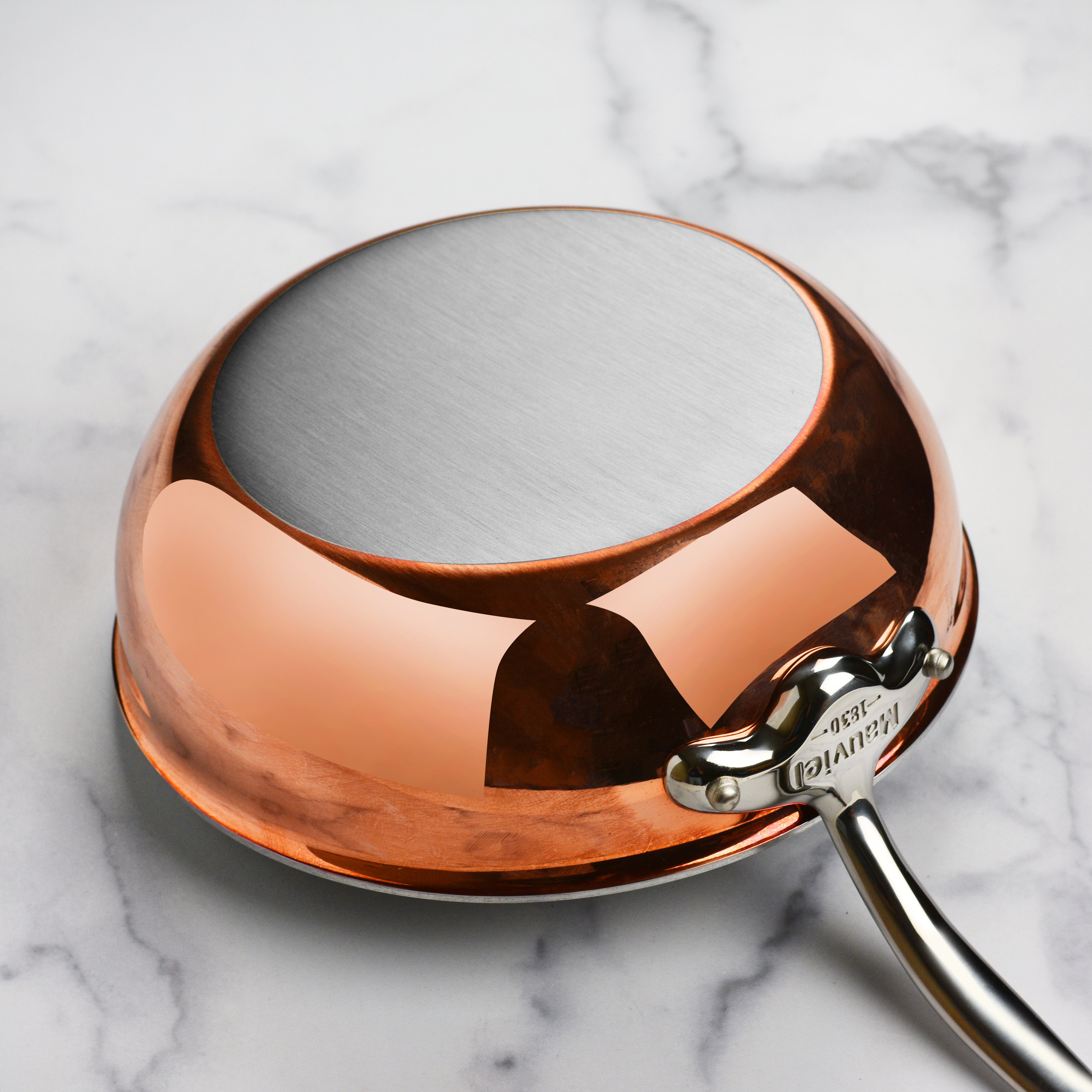 Close-up view of the copper sauté pans stainless steel rivets and finish.