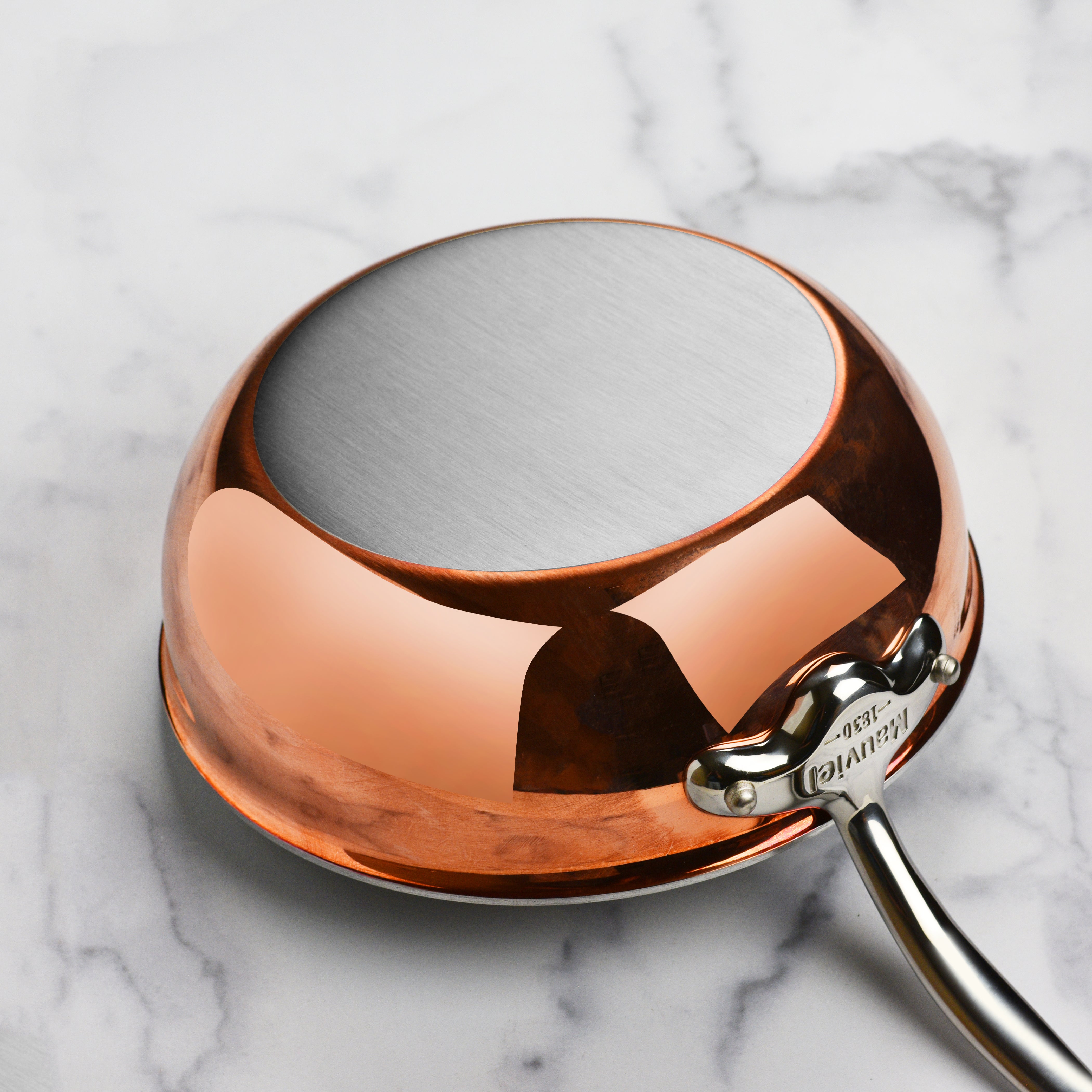 Close-up of the copper lid with cast stainless steel handle, showcasing durability and style of Mauviel cookware