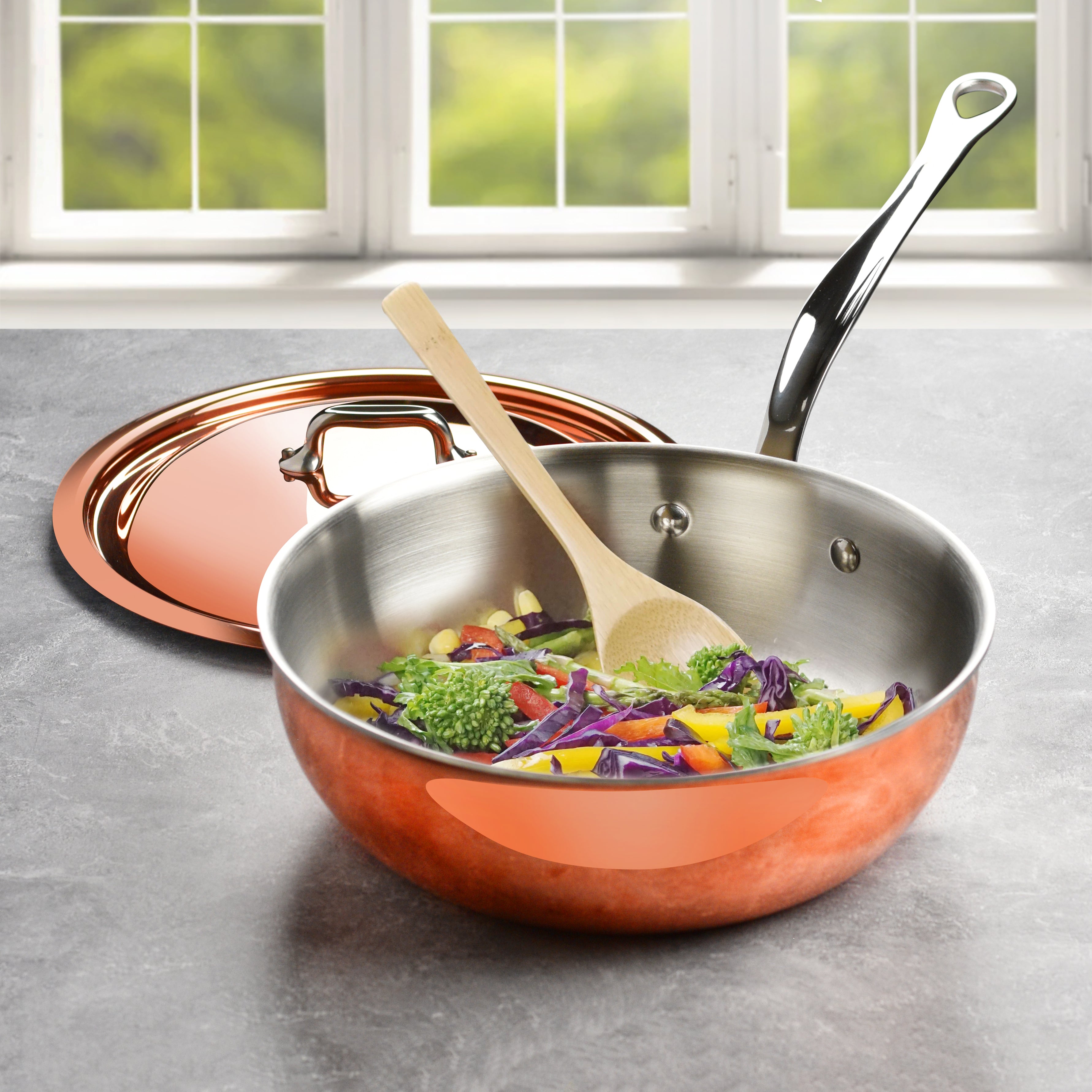 Copper saucepan with lid from Mauviel, highlighting the flared rim for drip-free pouring.