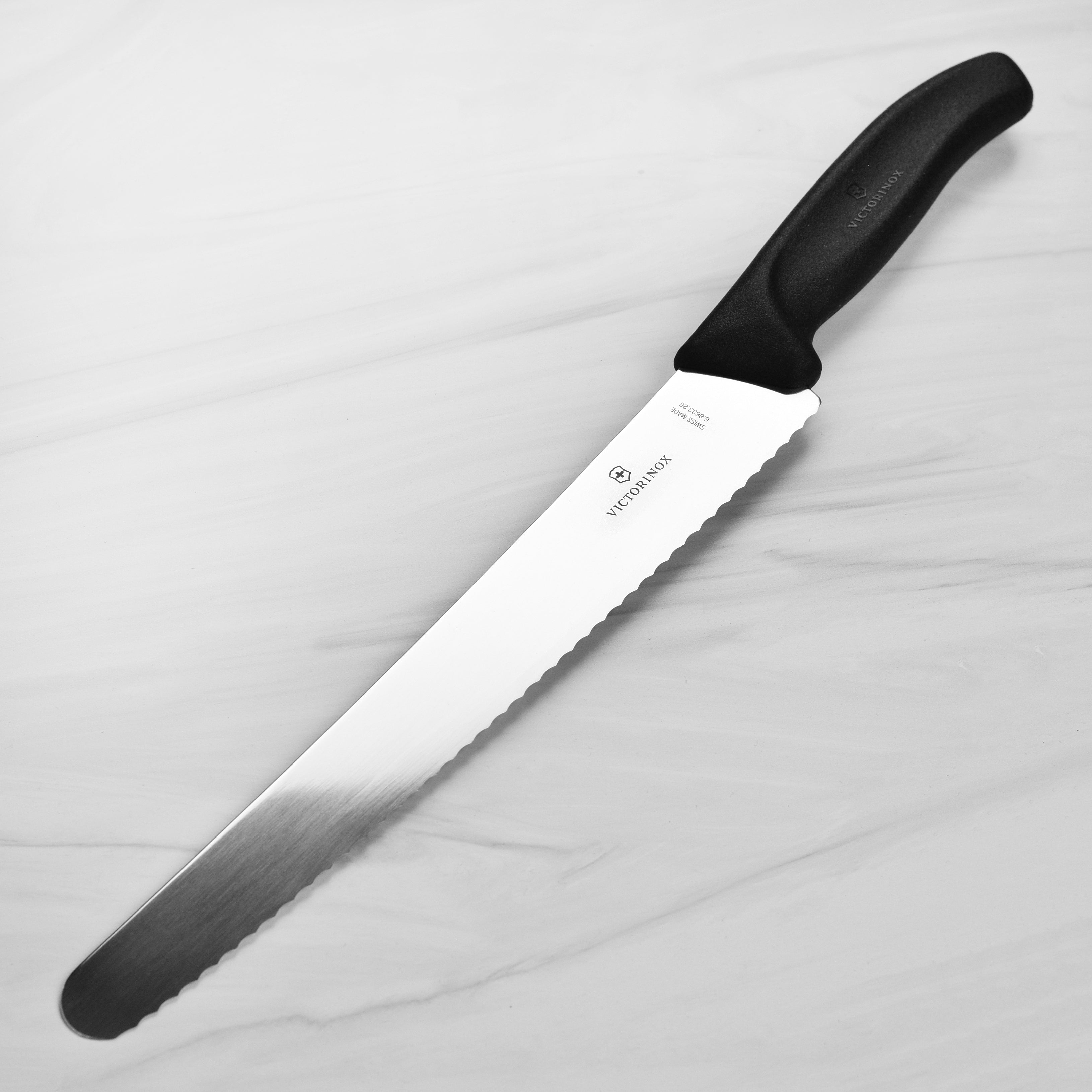 Victorinox Swiss Classic Bread Knife from the side, showcasing the blade's sharpness and Fibrox handle.