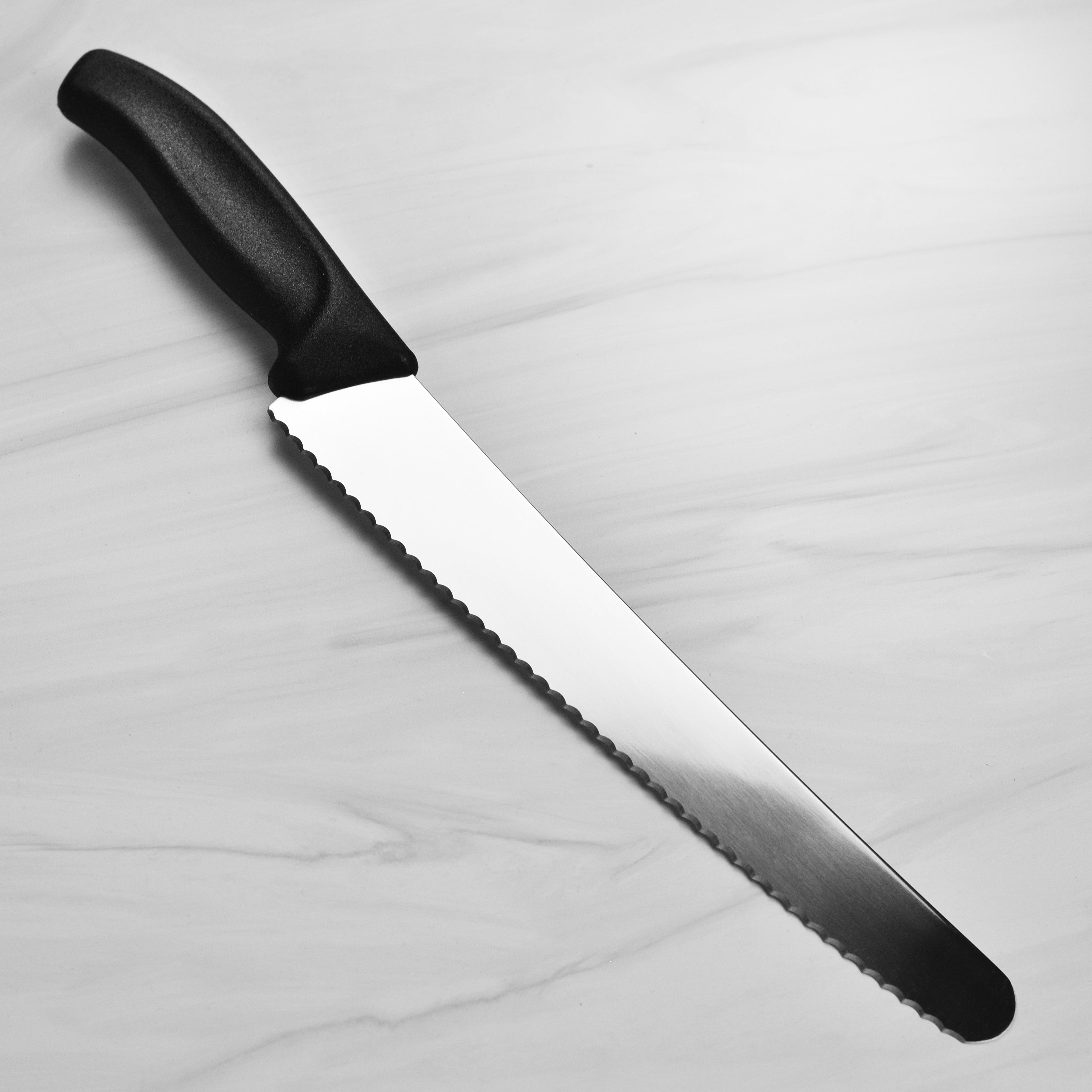 Victorinox Swiss Classic Bread Knife displayed on a wooden cutting board, emphasizing its design and quality.
