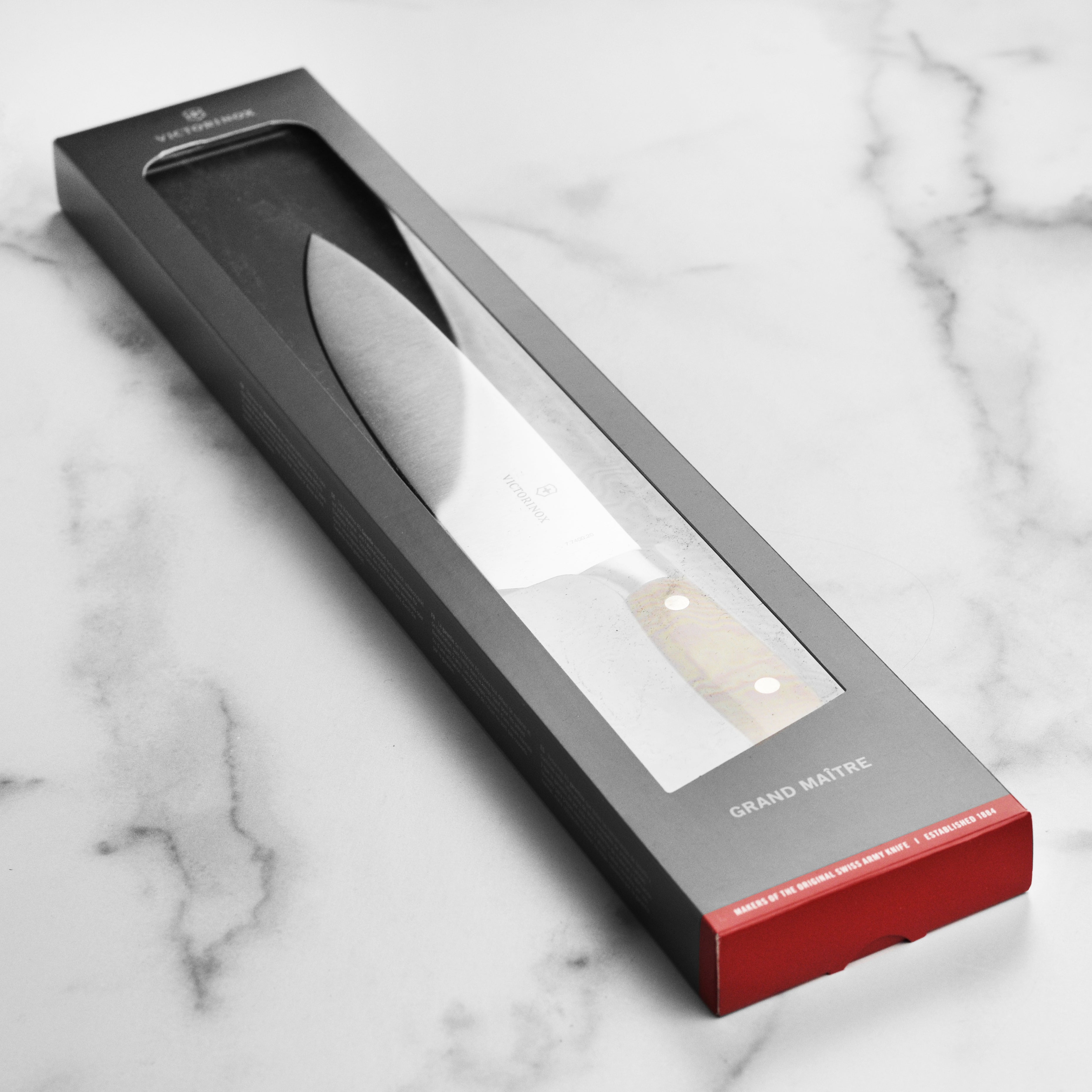 Victorinox Grand Maitre Wood 8-inch chefs knife with wooden handle on a cutting board