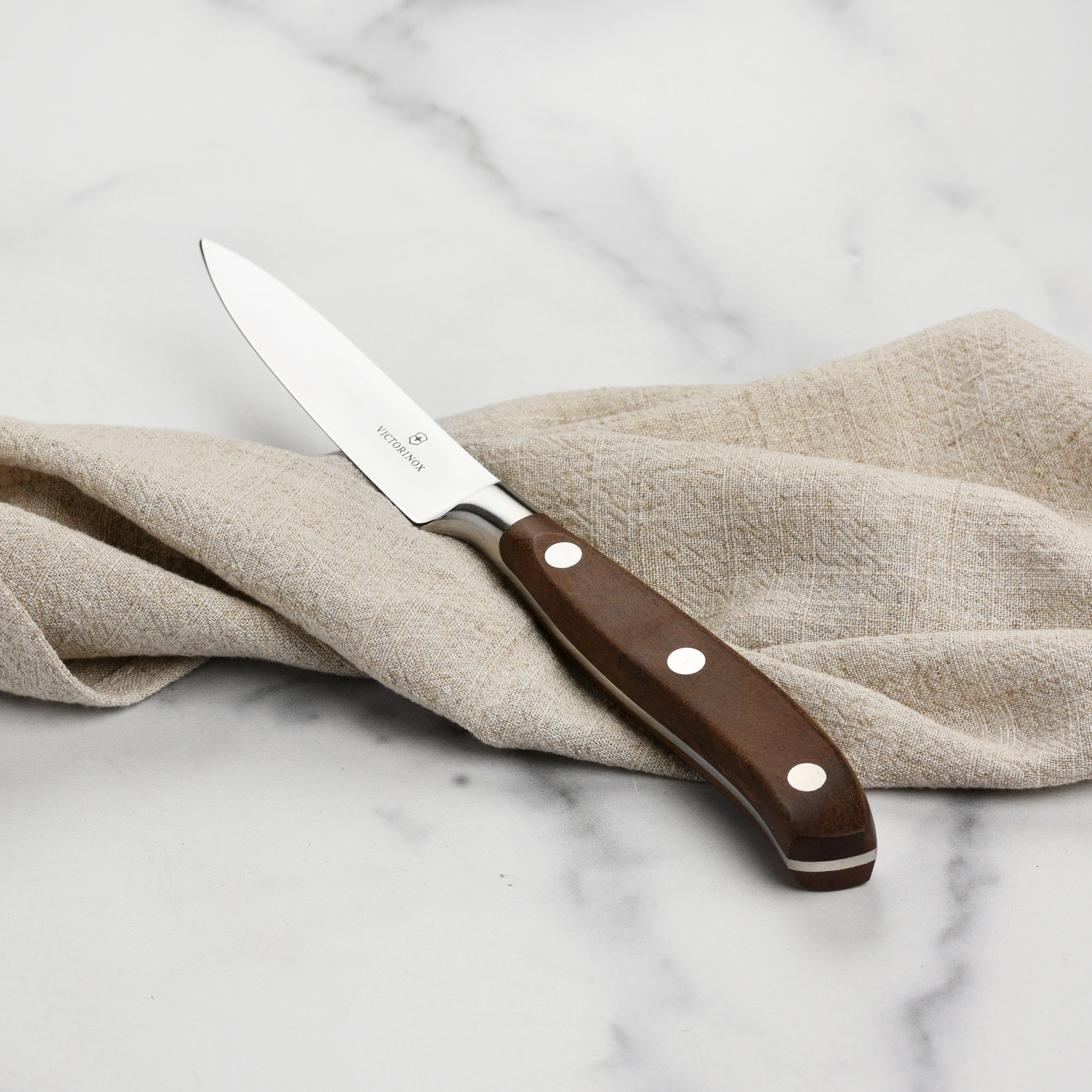 Forged knife in hand slicing apple skin with precision