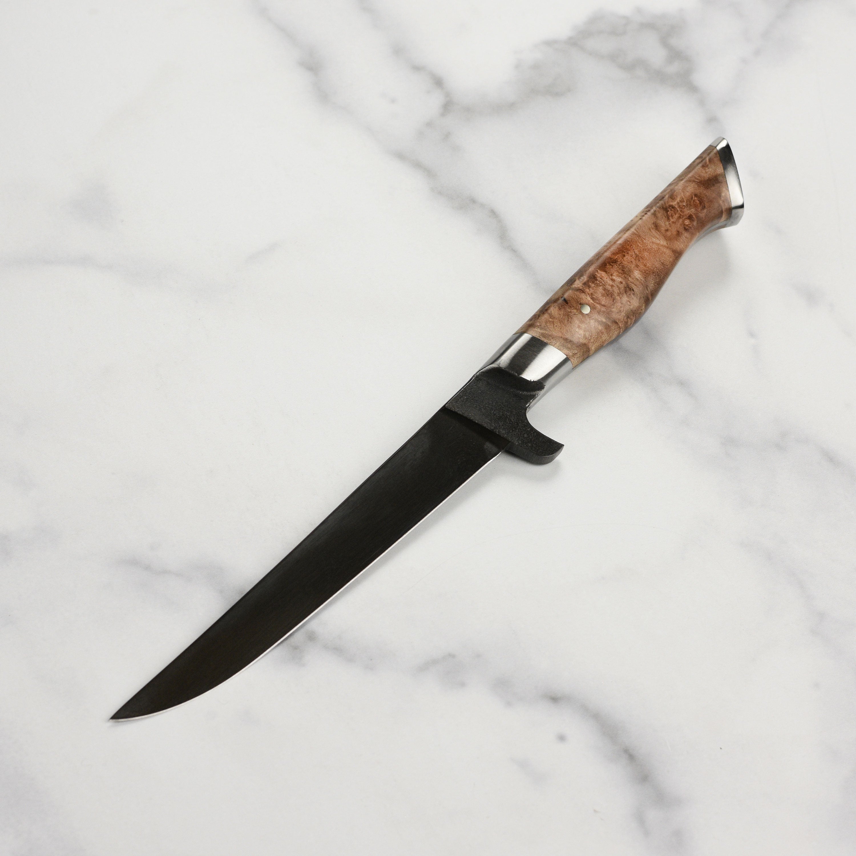 Steelport boning knife in use, demonstrating its precision in filleting fish.