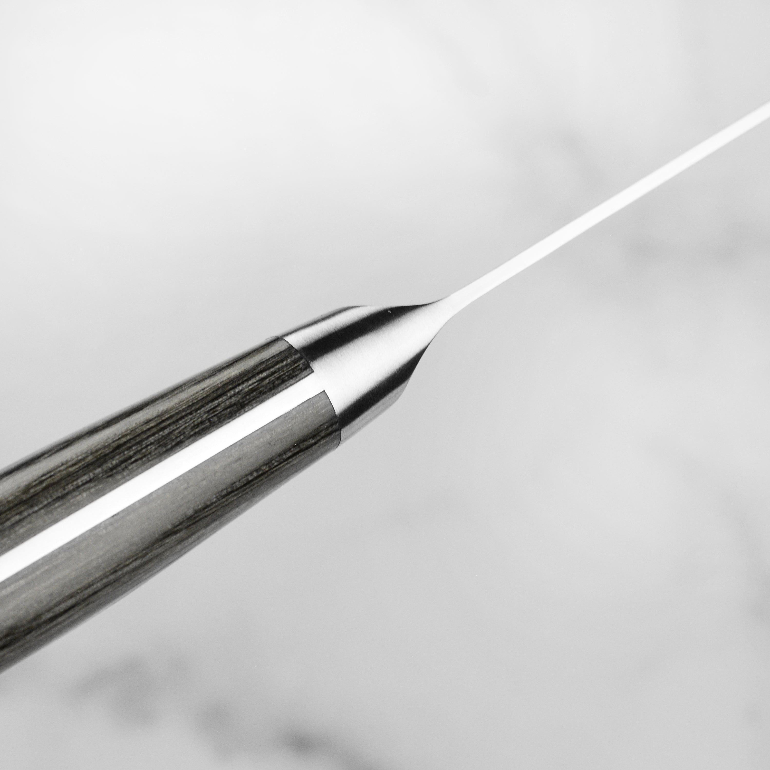 Close-up of the blade edge and handle of the Shun Nagare Santoku knife