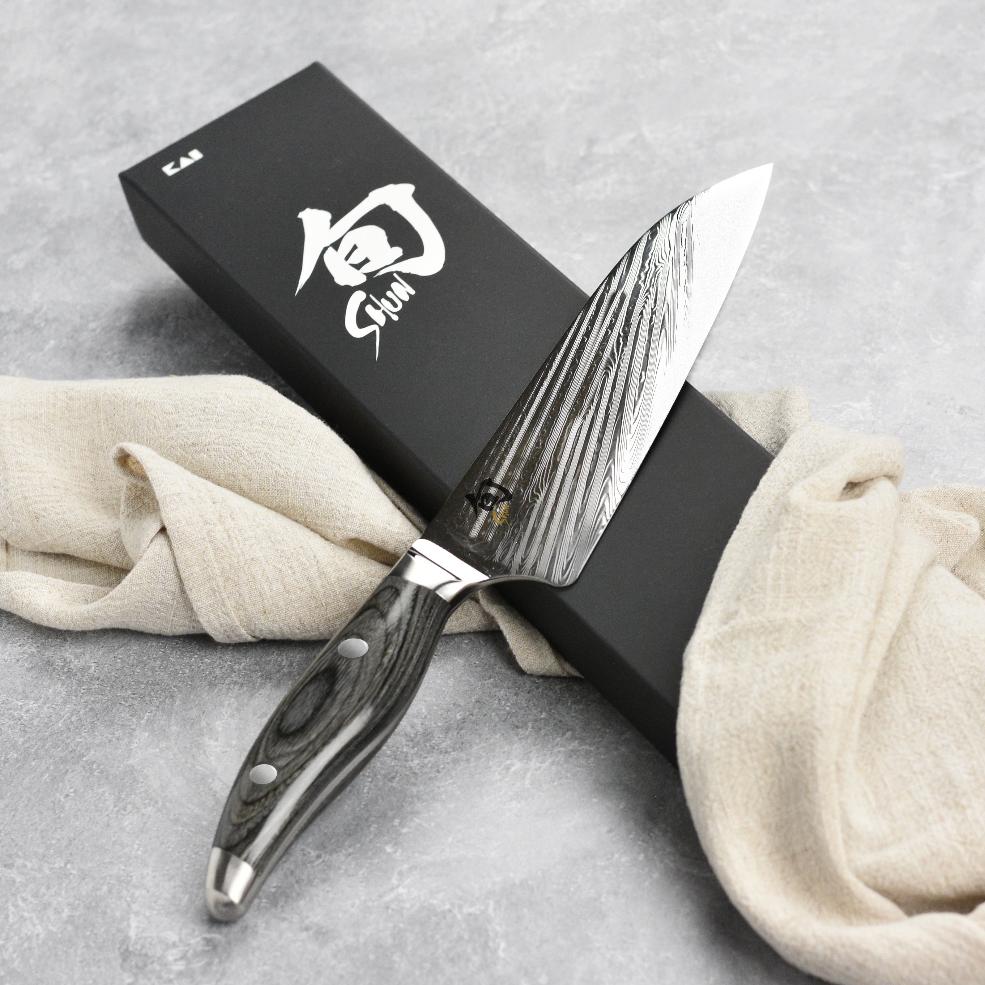 Close-up of the blade edge and handle of the Shun Nagare Santoku knife
