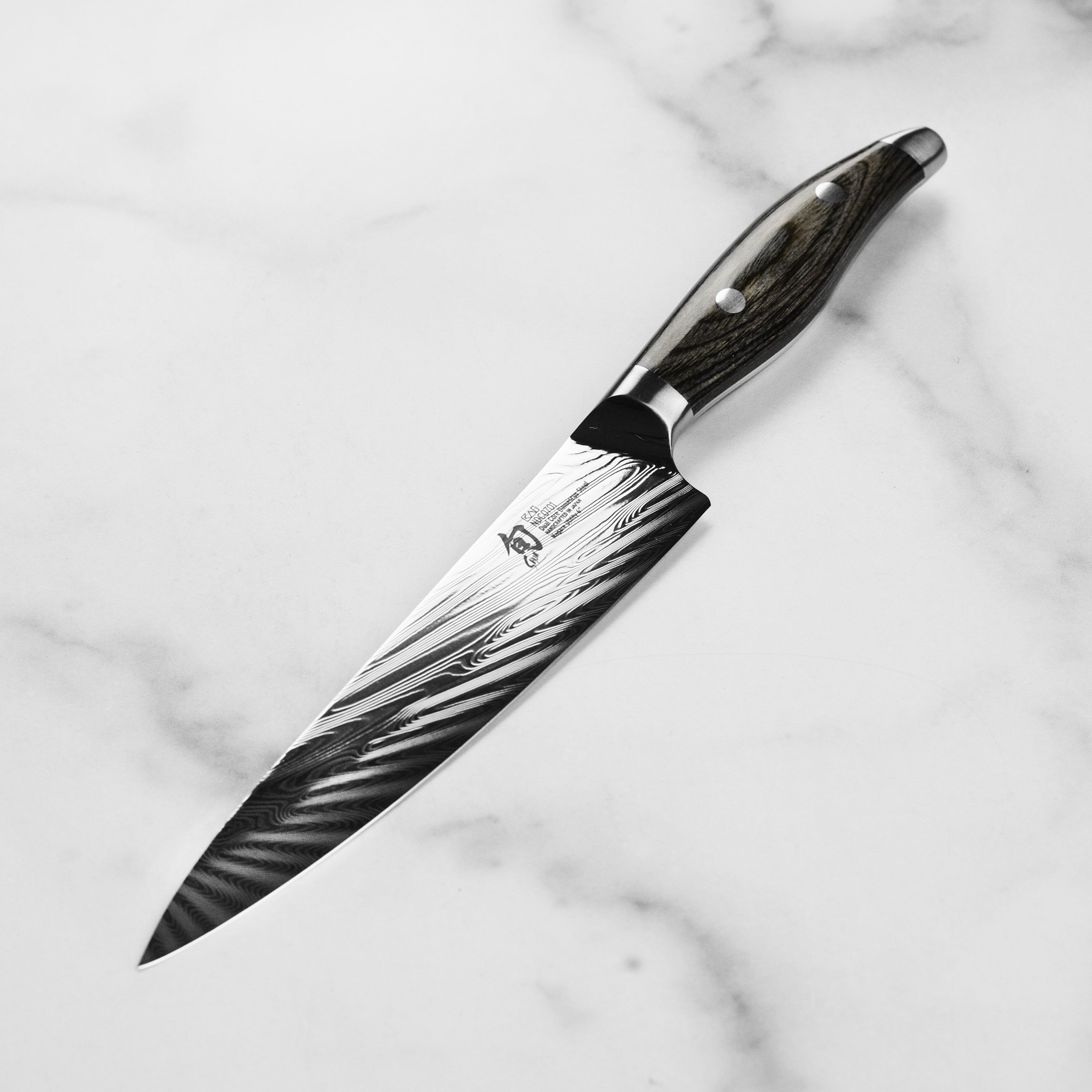 Close-up of the Shun Nagare knifes pakkawood handle, highlighting its double-riveted design for better grip.