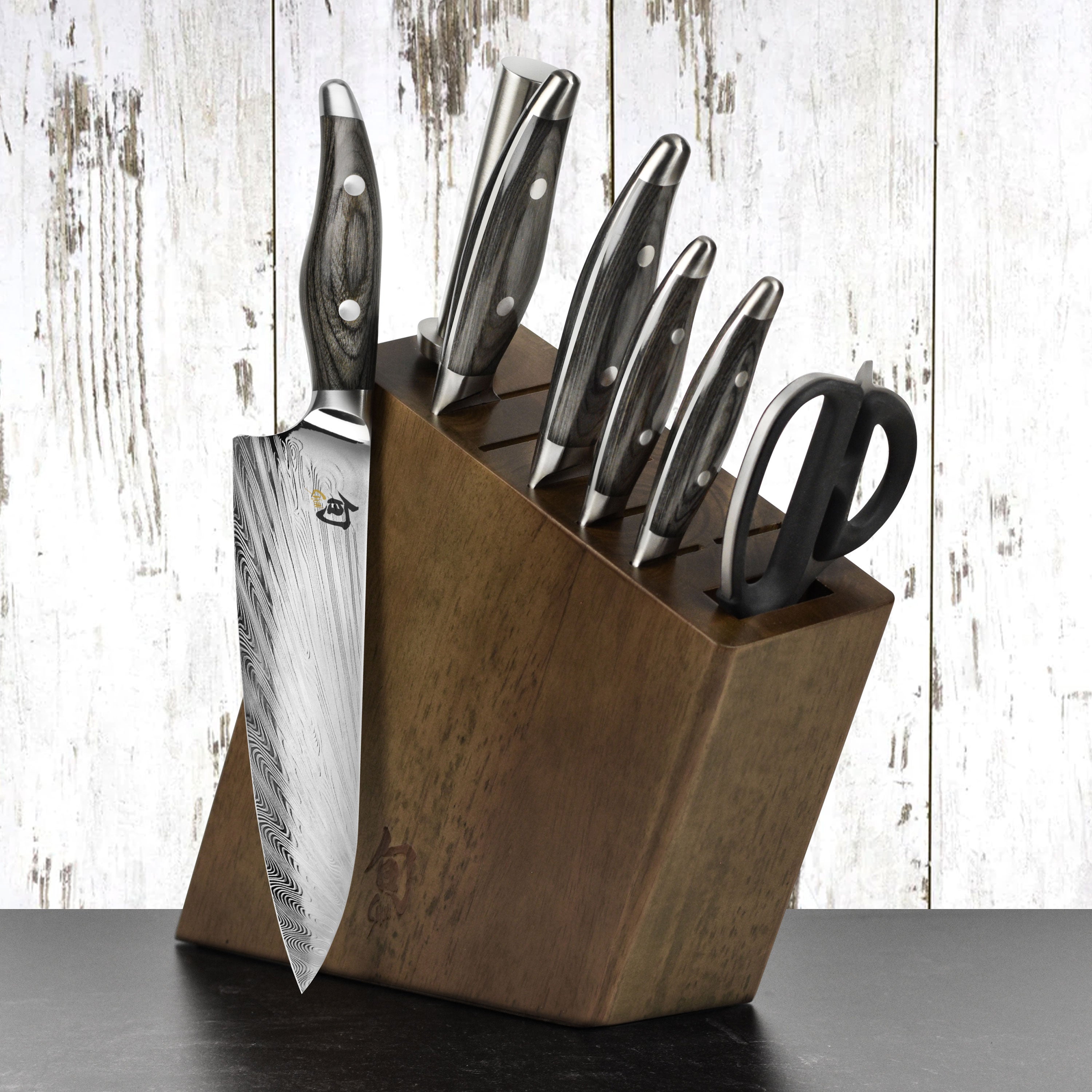 Close-up view of the Damascus knife set showing the intricate blade design and pakkawood handle.