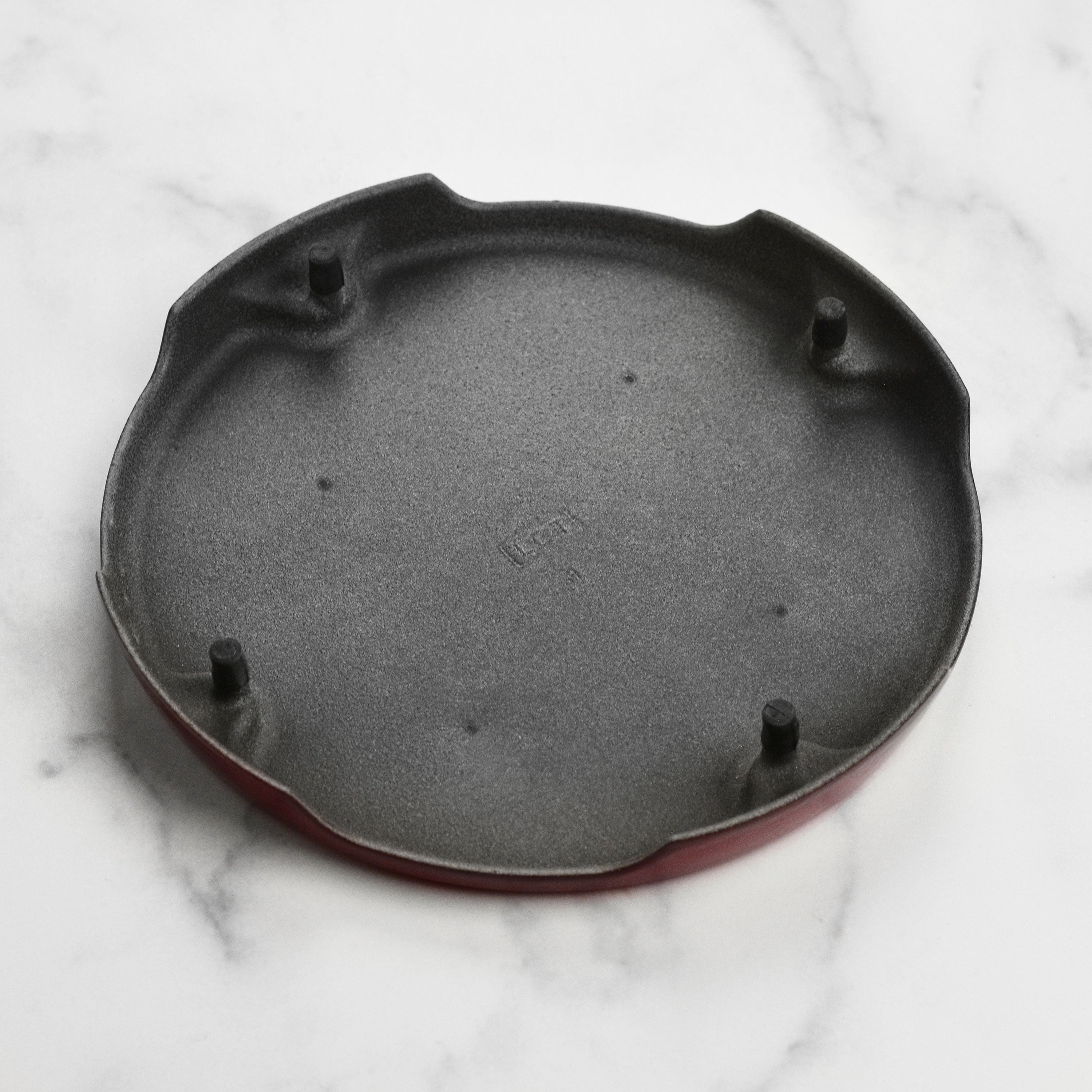Using the Le Creuset cast iron trivet to hold a hot pot during meal prep