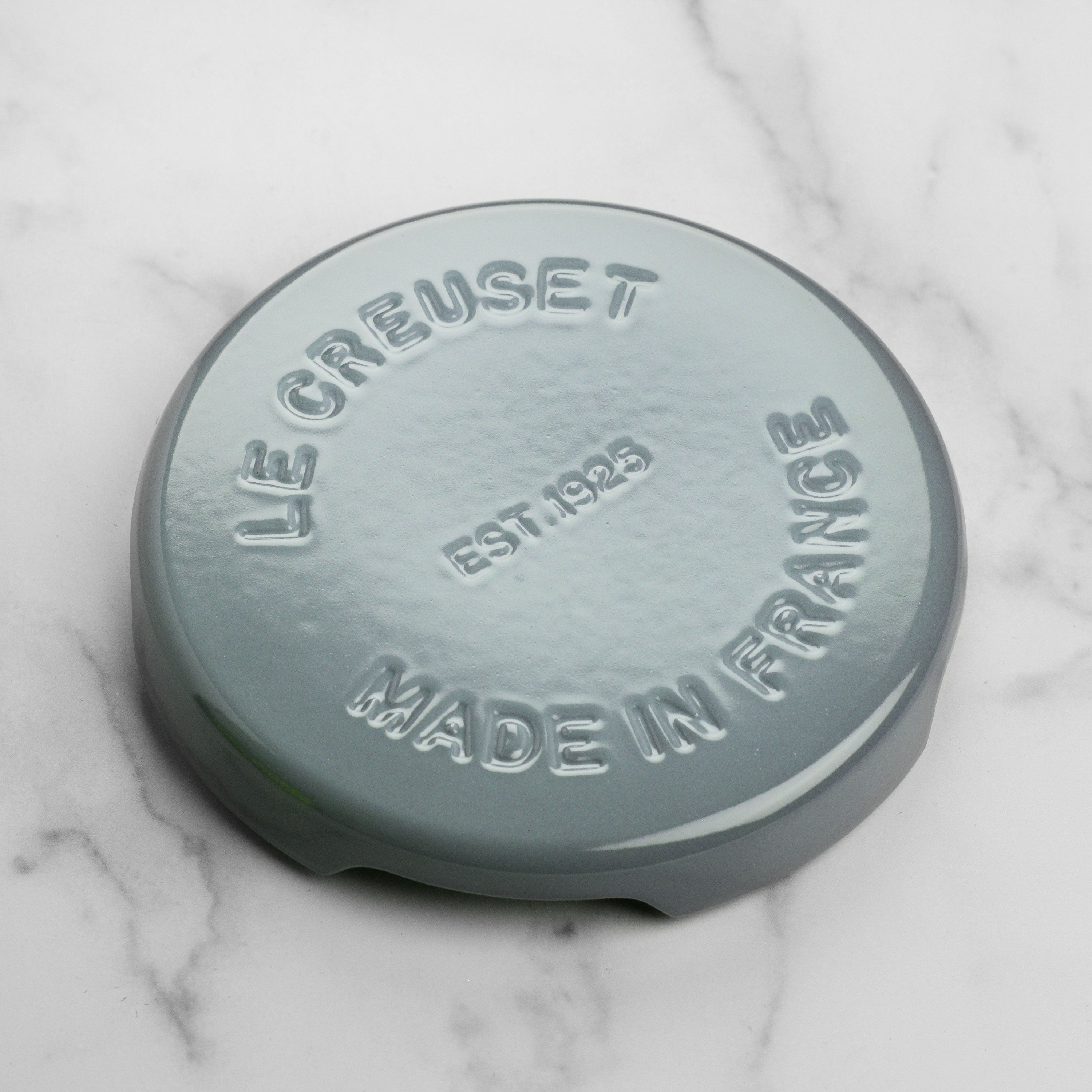 Le Creuset round trivet showcasing elevated design and enamel finish