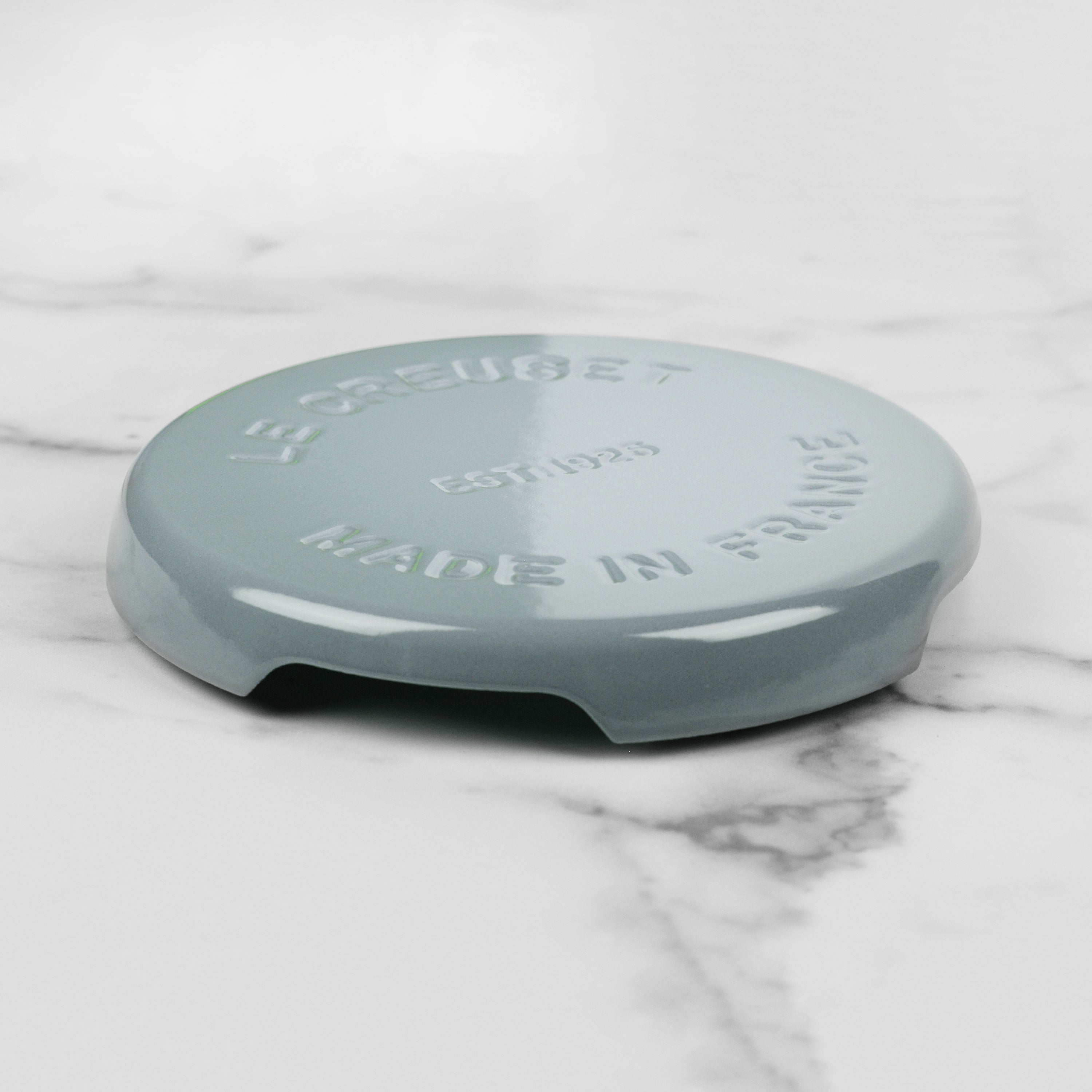 Close-up of Le Creuset enamel round trivet demonstrating quality craftsmanship