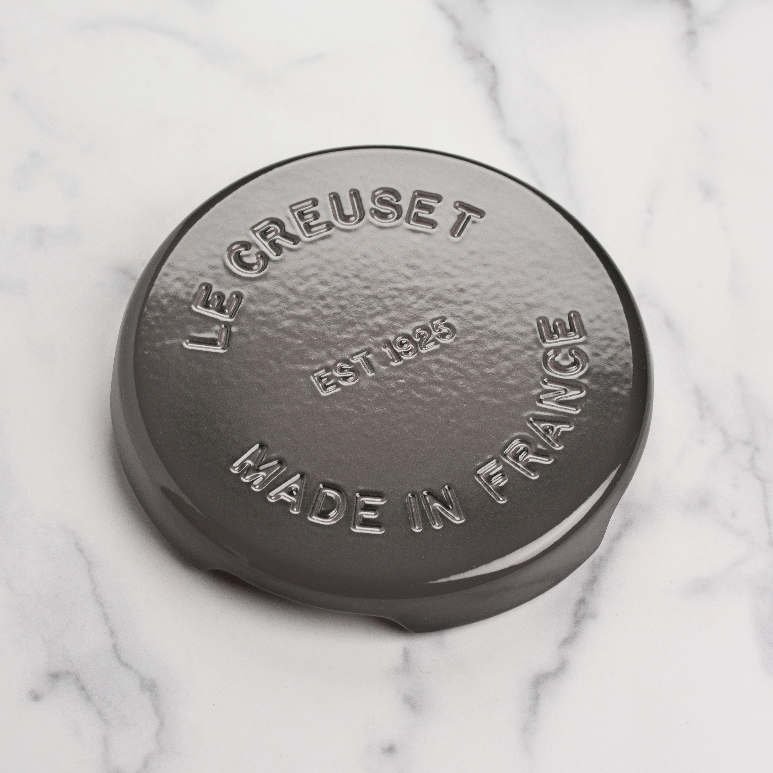 Close-up of Le Creuset signature cast iron trivet highlighting its enamel finish.