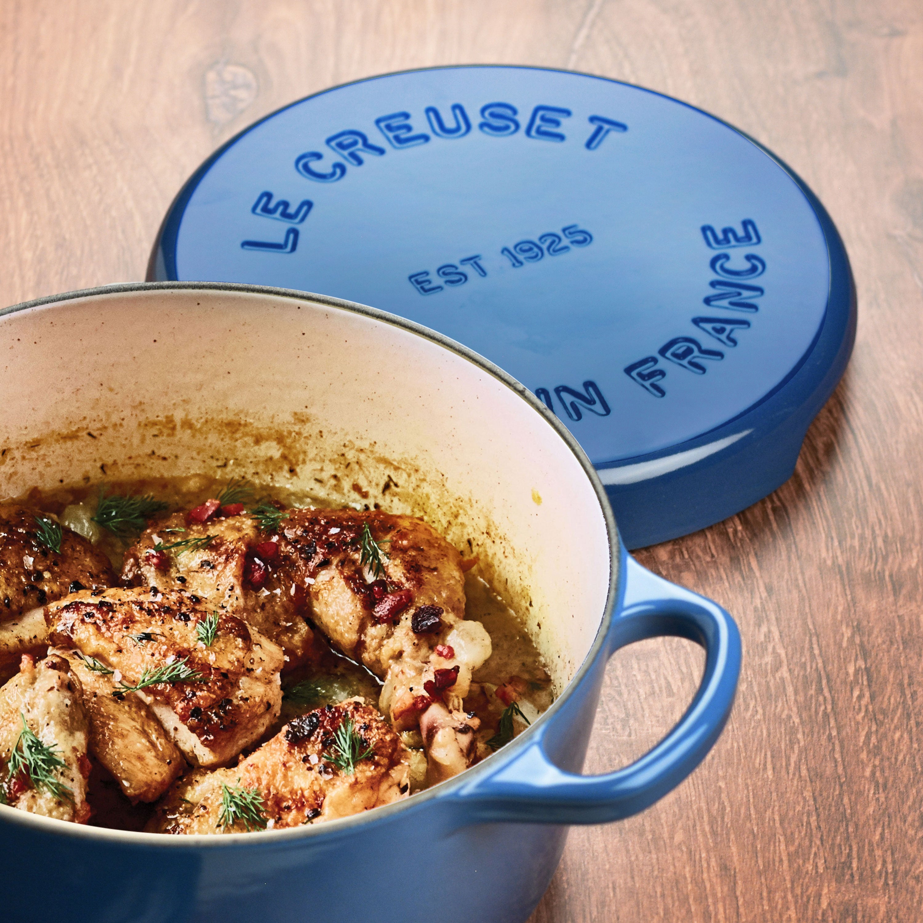 Le Creuset trivet in use, protecting a wooden table from a hot pot.