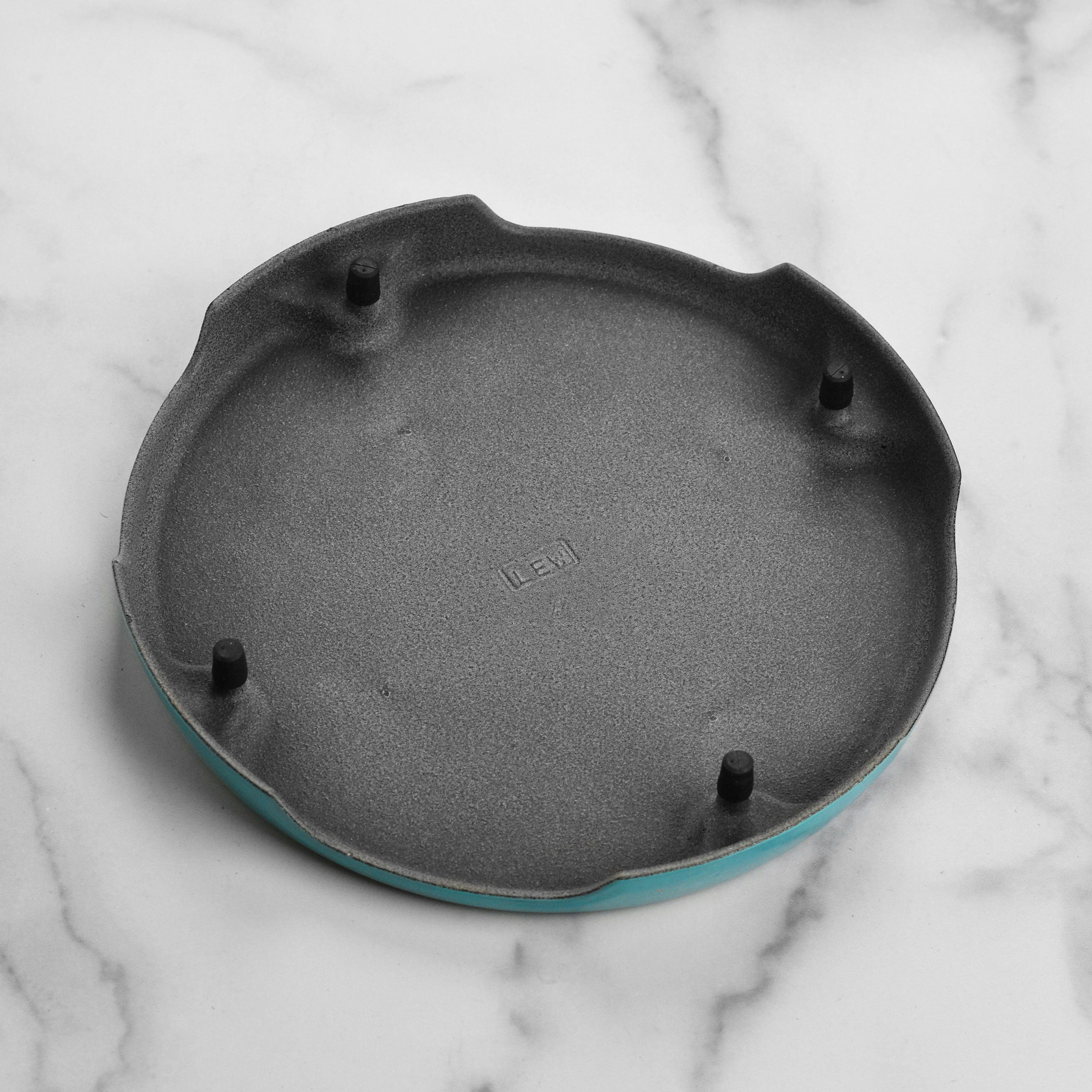 Le Creuset cast iron trivet showcasing its elegant design and vibrant Caribbean color.