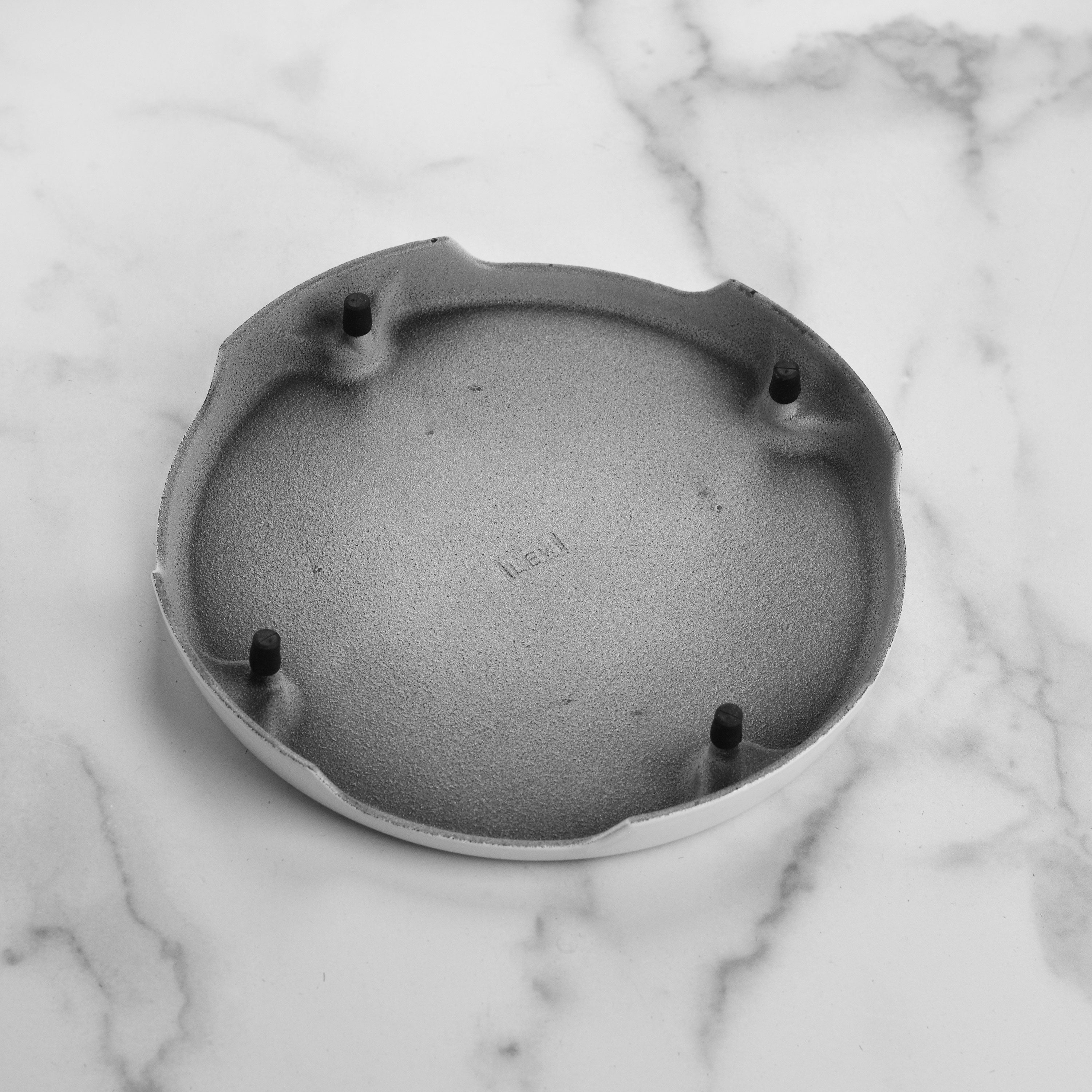 Le Creuset cast iron trivet elevating hot dishes on a kitchen counter