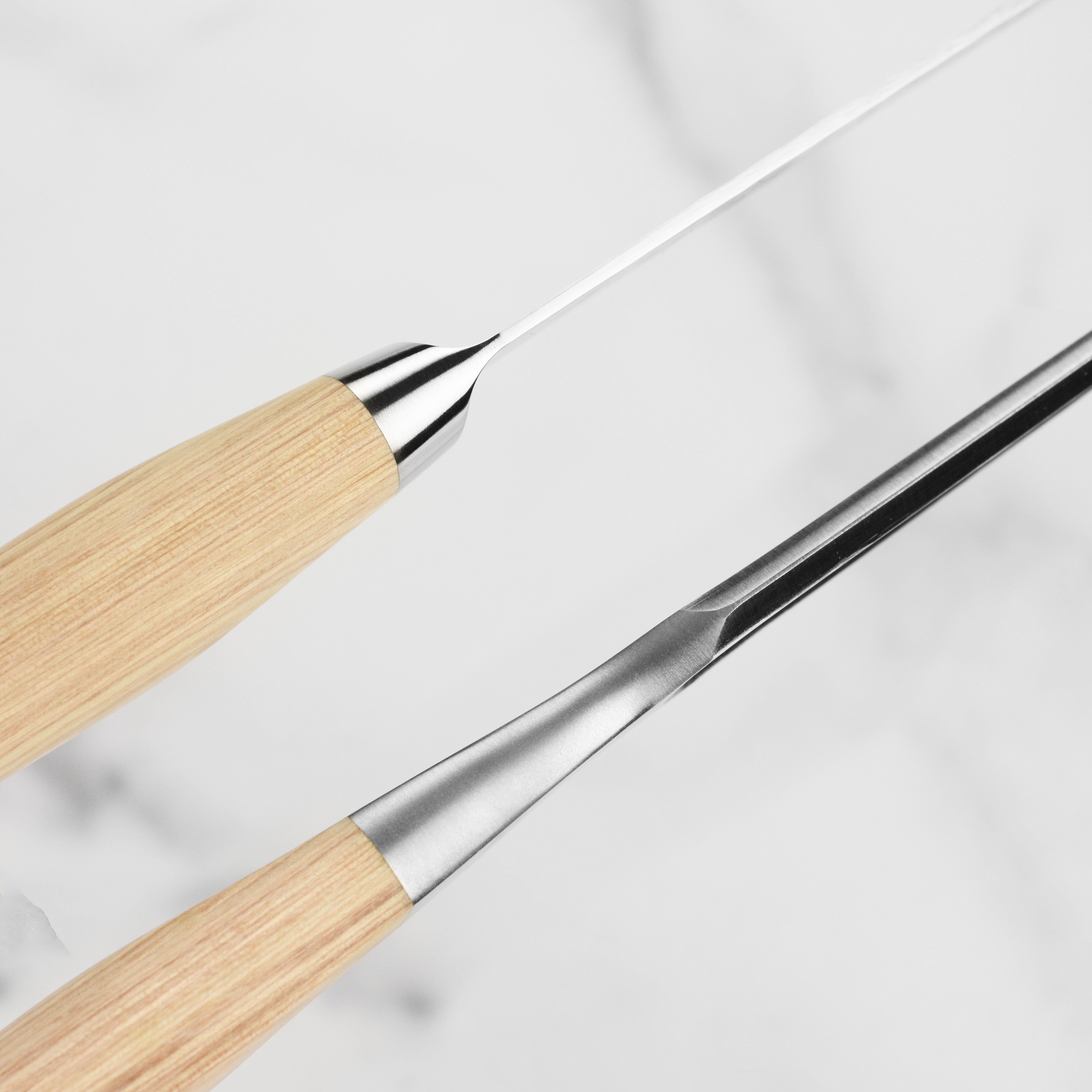 Shun Premier Blonde carving set in action, slicing through a perfectly cooked roast, demonstrating its effectiveness.