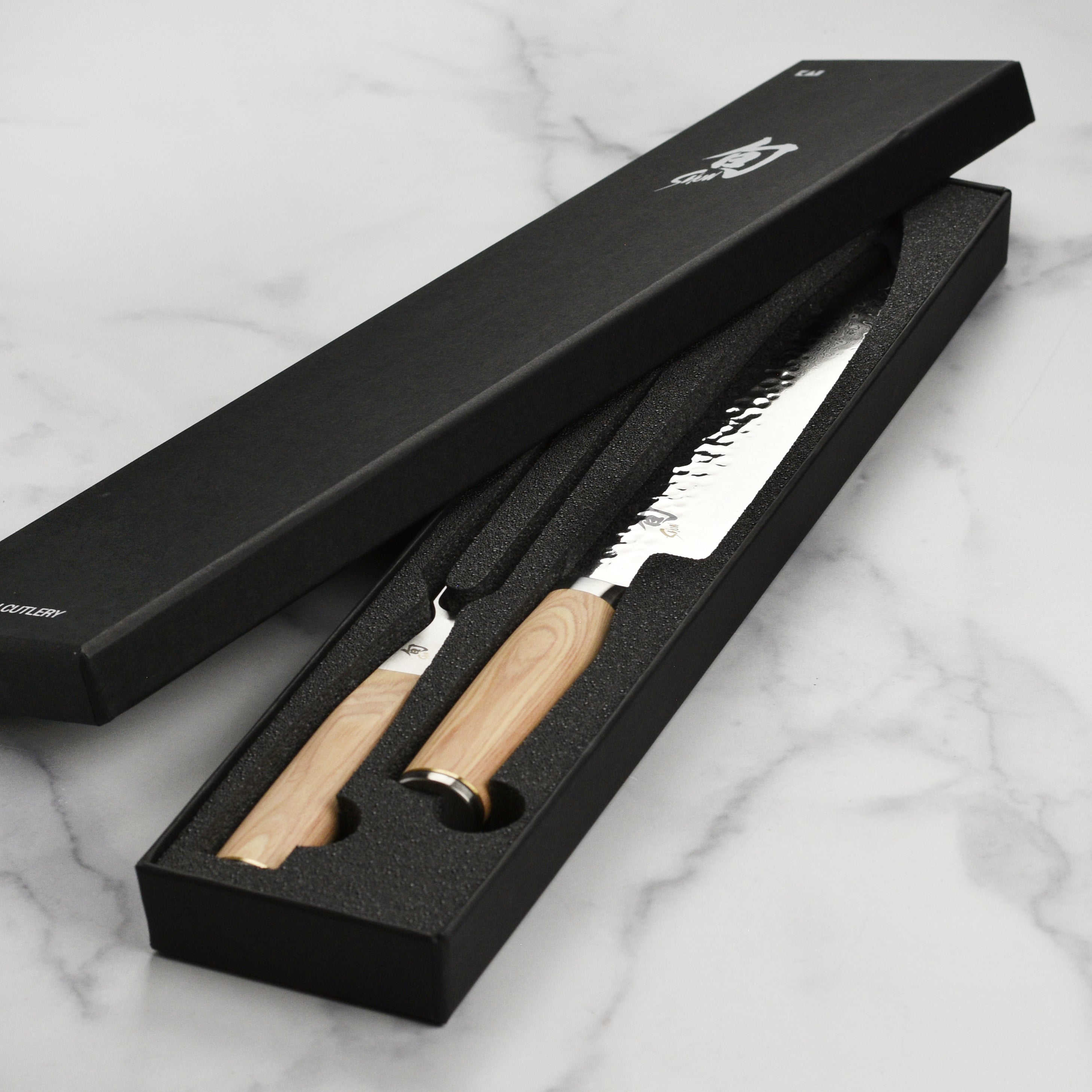 Shun Premier Blonde carving set in action, slicing through a perfectly cooked roast, demonstrating its effectiveness.