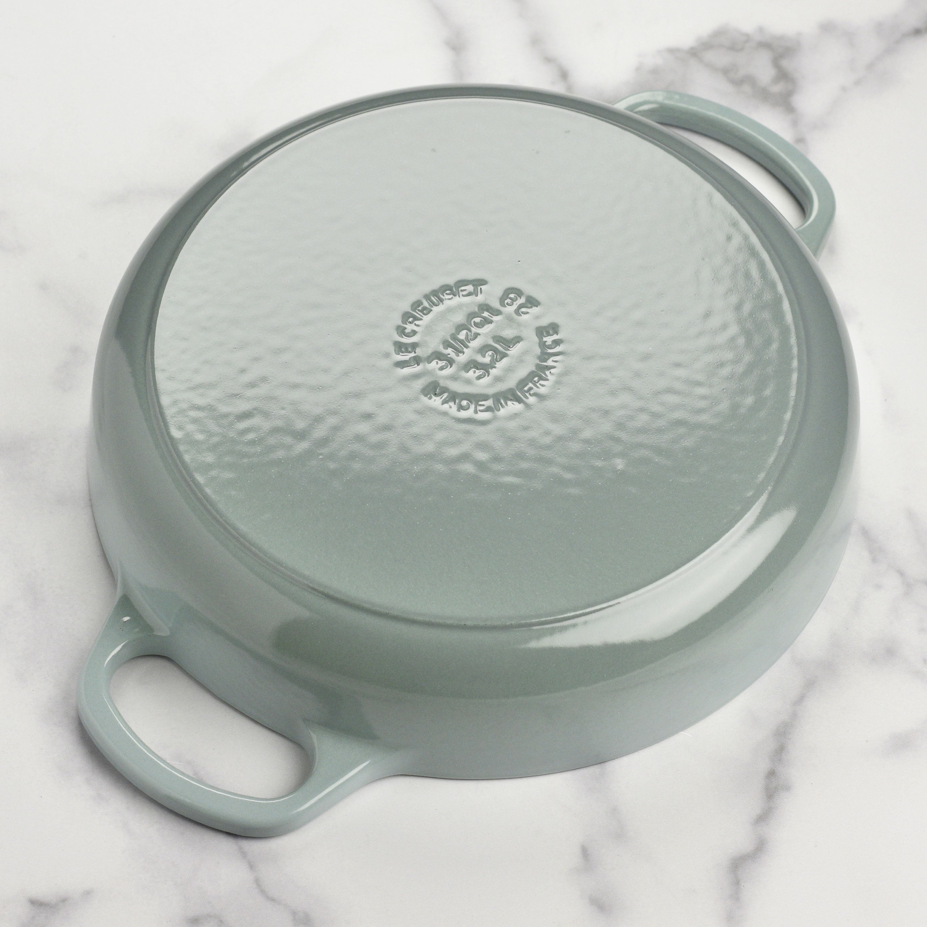 Le Creuset everyday pan in use for sautéing vegetables on a gas stovetop.