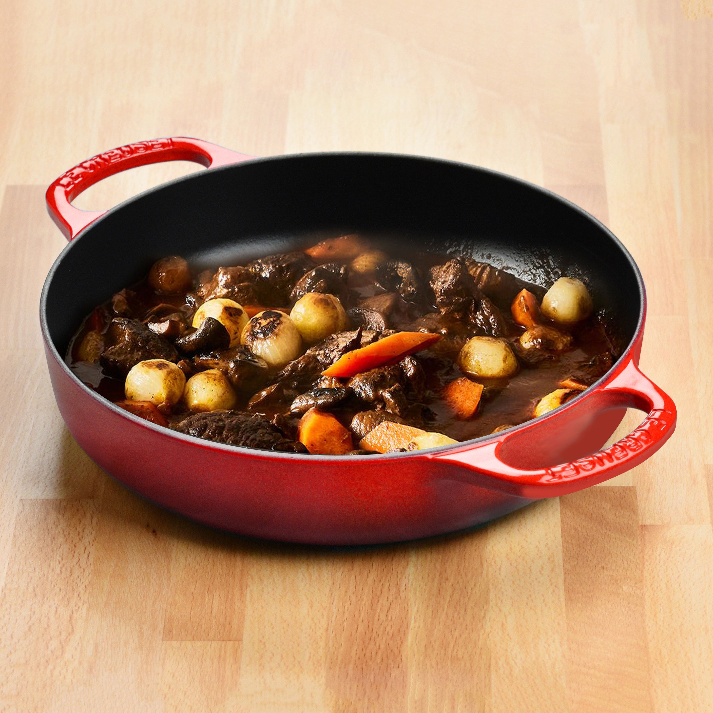 Close-up view of the black satin interior of the Le Creuset cast iron pan, highlighting its cooking performance.
