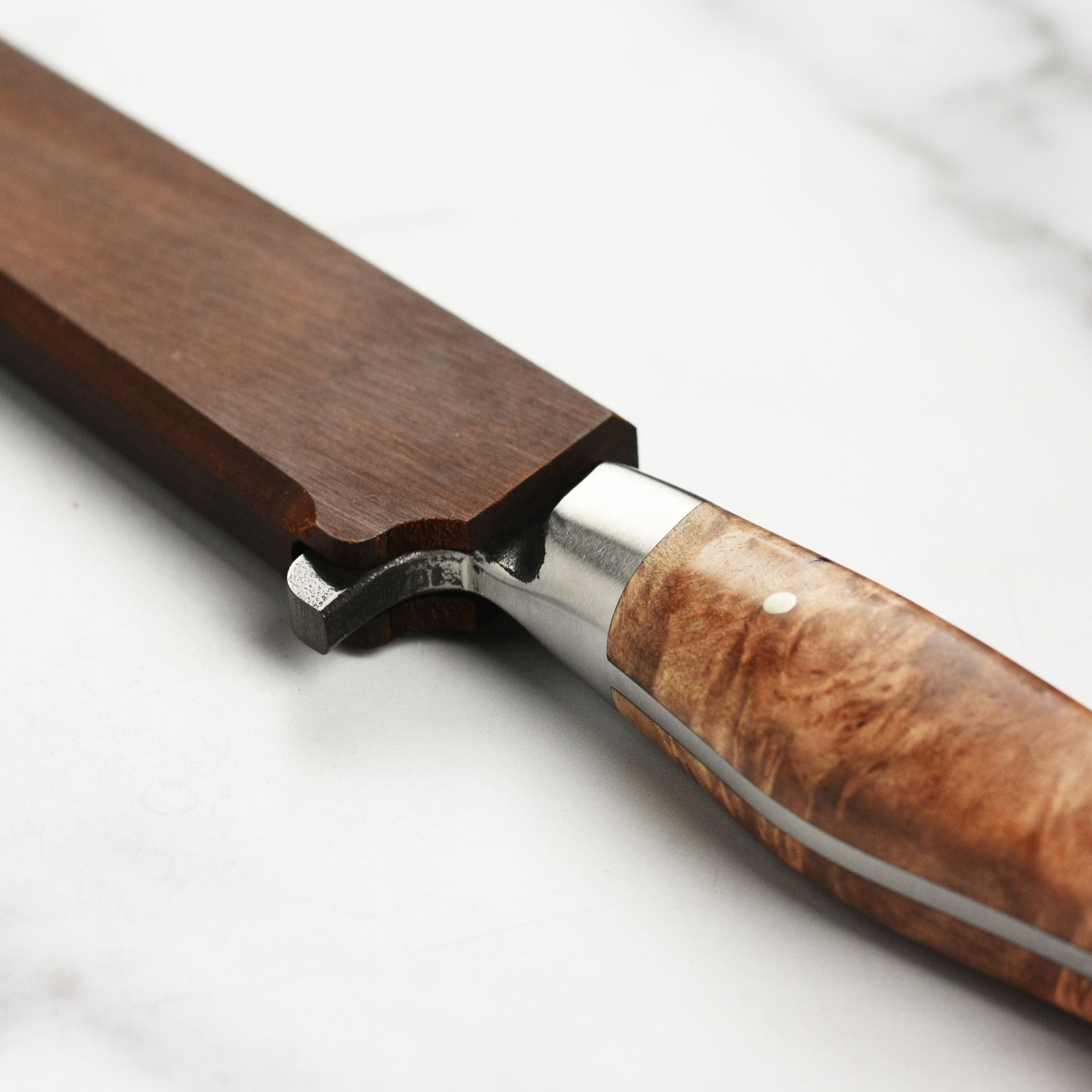 Elegant Oregon maple wooden magnetic knife sheath displayed on a kitchen countertop.