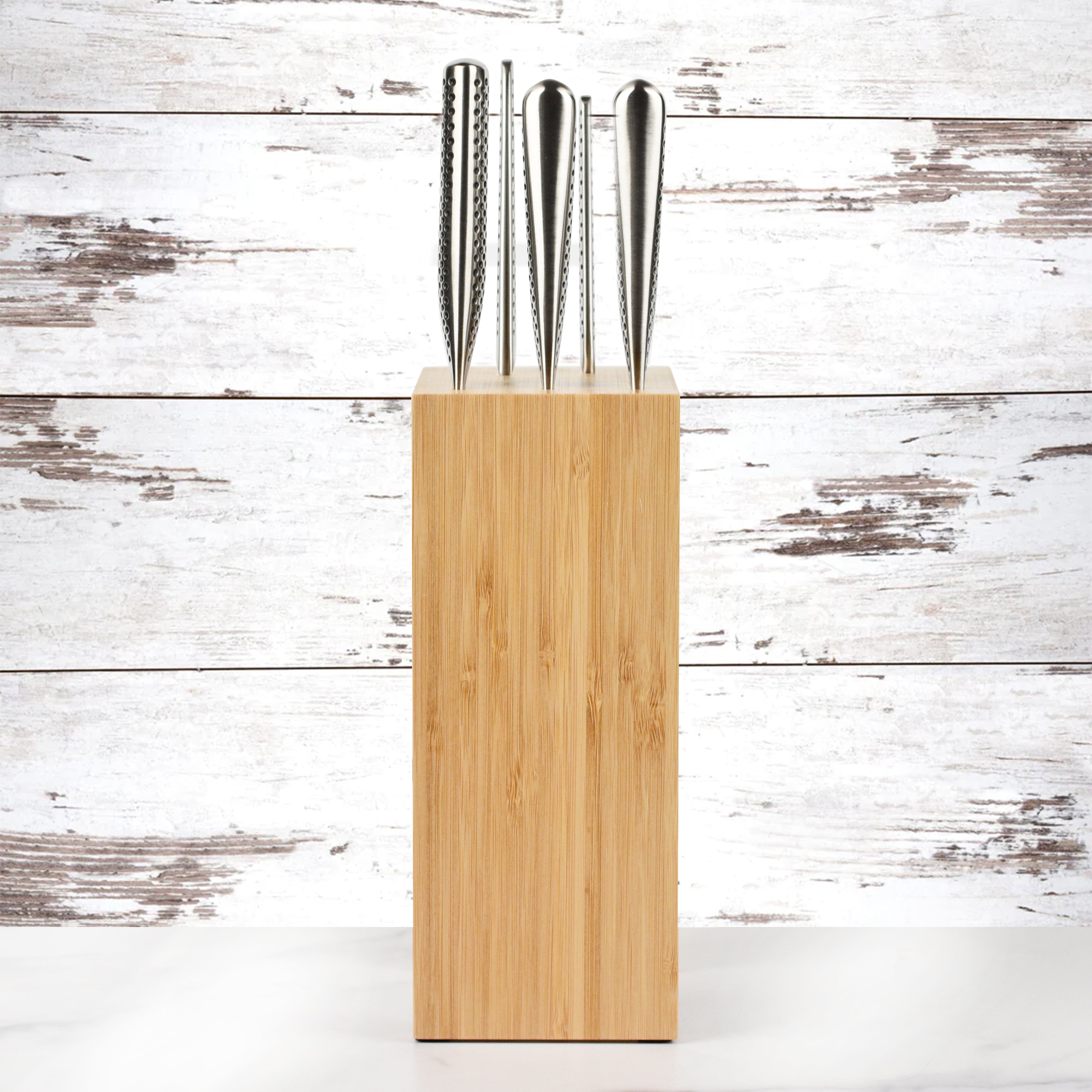 Chef using Global Osaka knives for slicing vegetables in a professional kitchen
