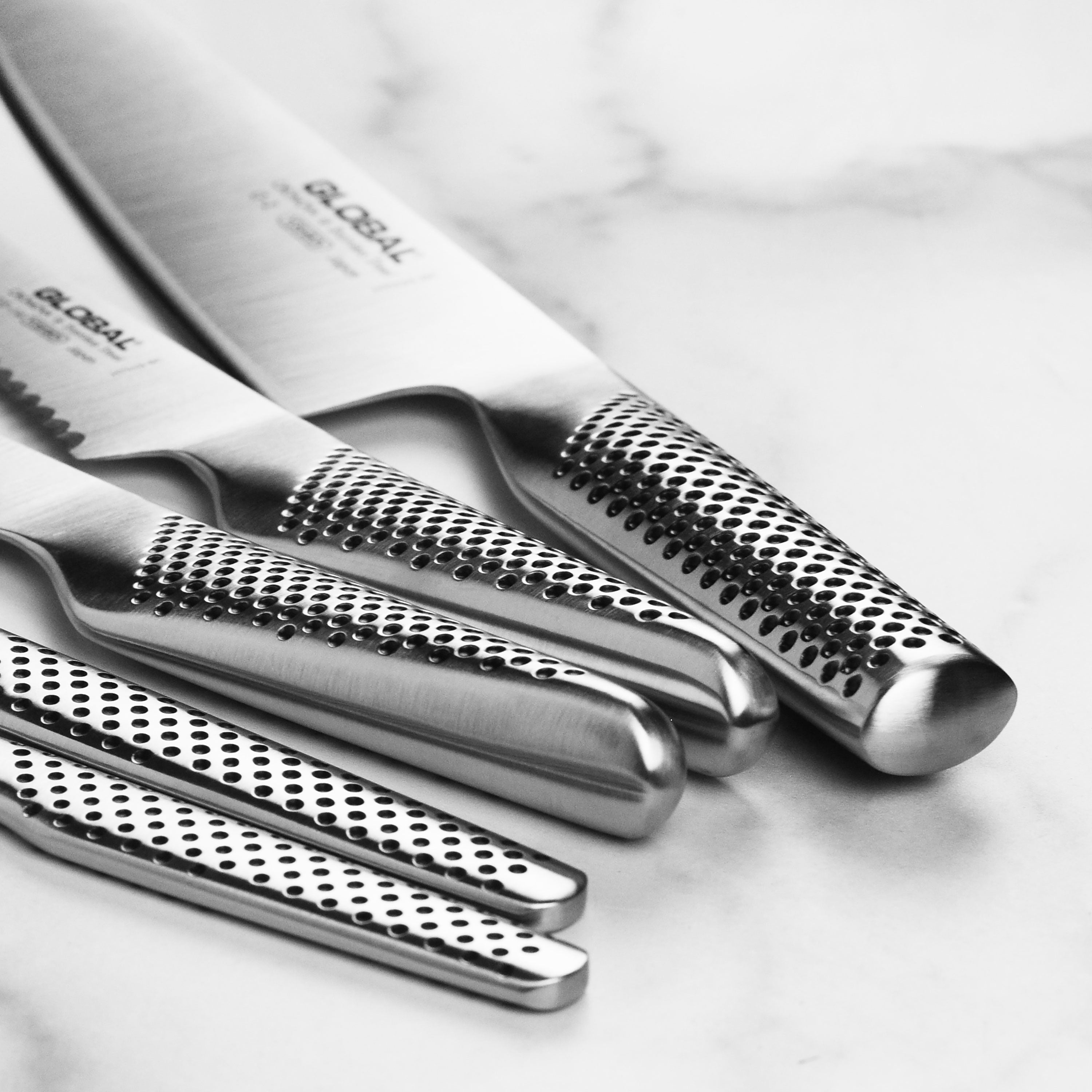 Close-up of Japanese knives with ergonomic handles and razor-sharp blades