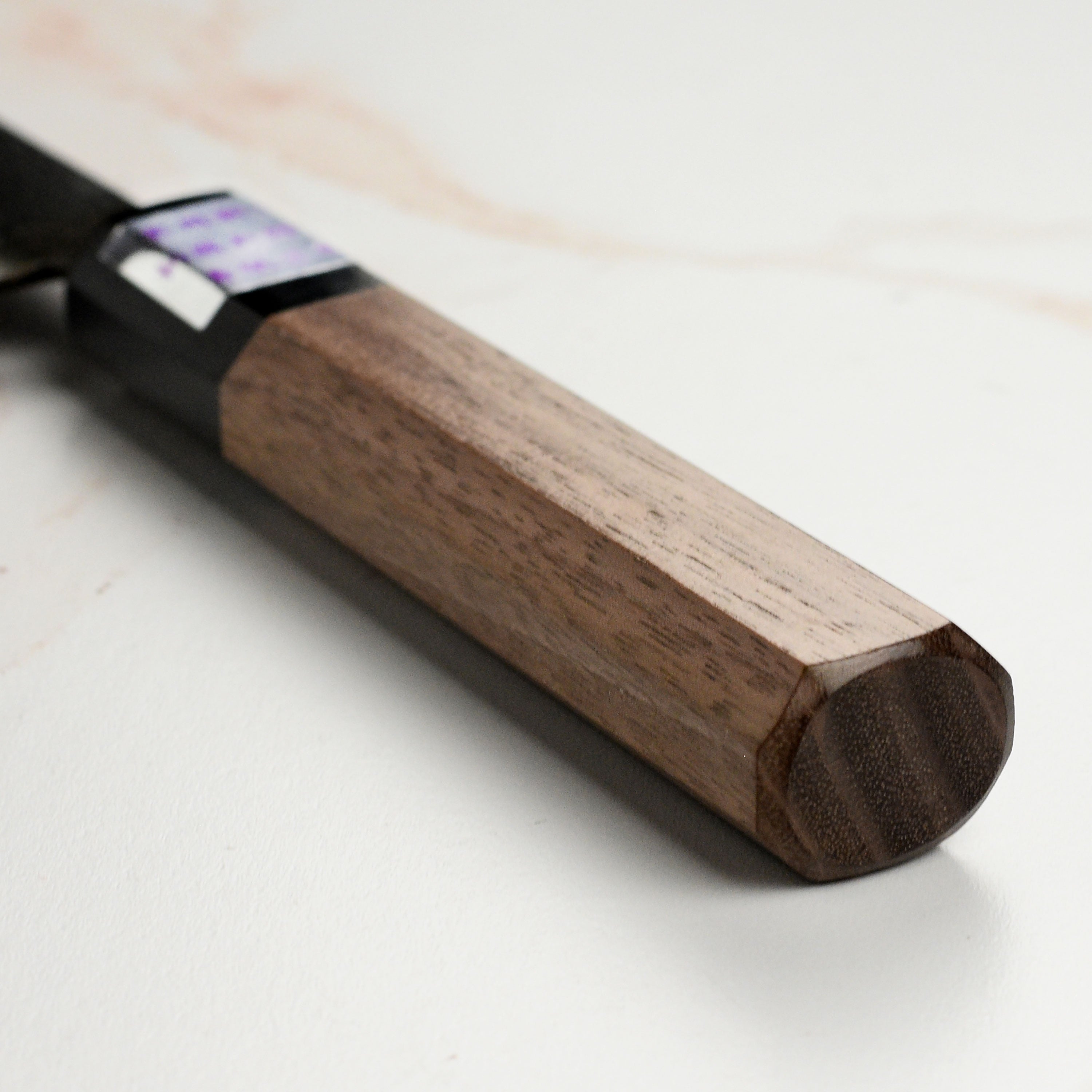Side angle of the Moritaka petty knife demonstrating its sharp edge and craftsmanship.