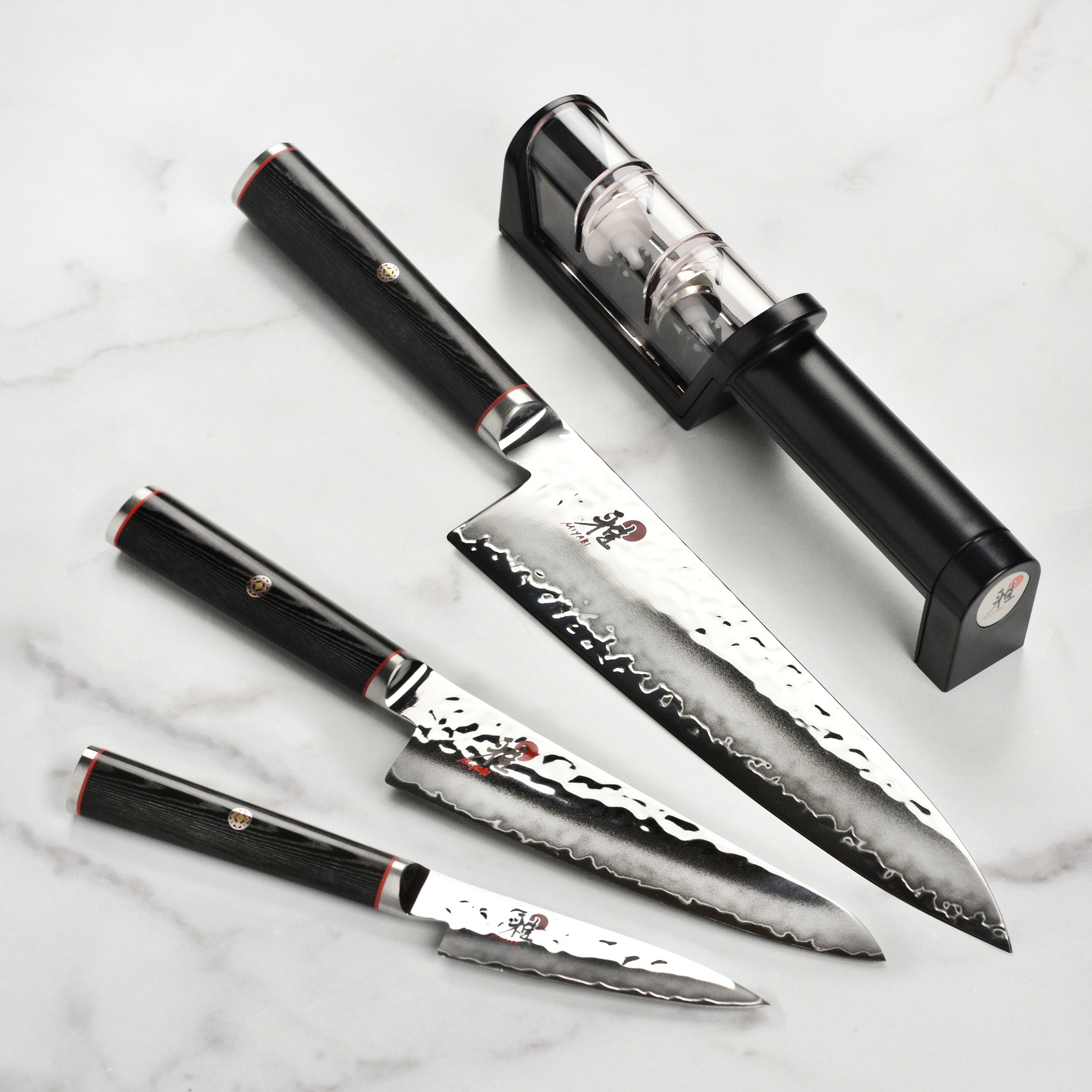 Miyabi Mizu SG2 knife set showcasing the elegant Damascus steel blades and Micarta handle from a side angle.