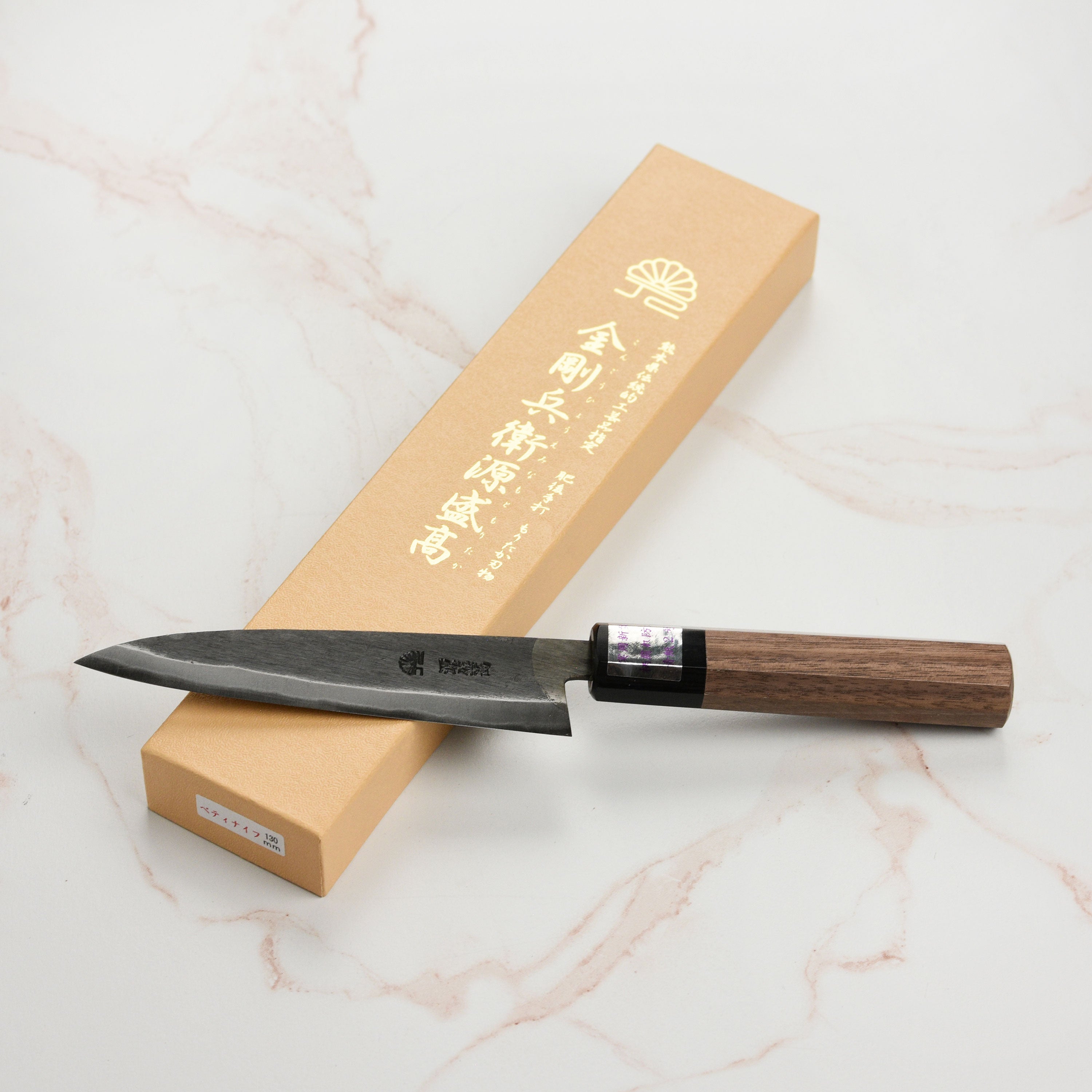 Top-down perspective of the Moritaka 5" Aogami #2 knife on a cutting board, ready for use in the kitchen.