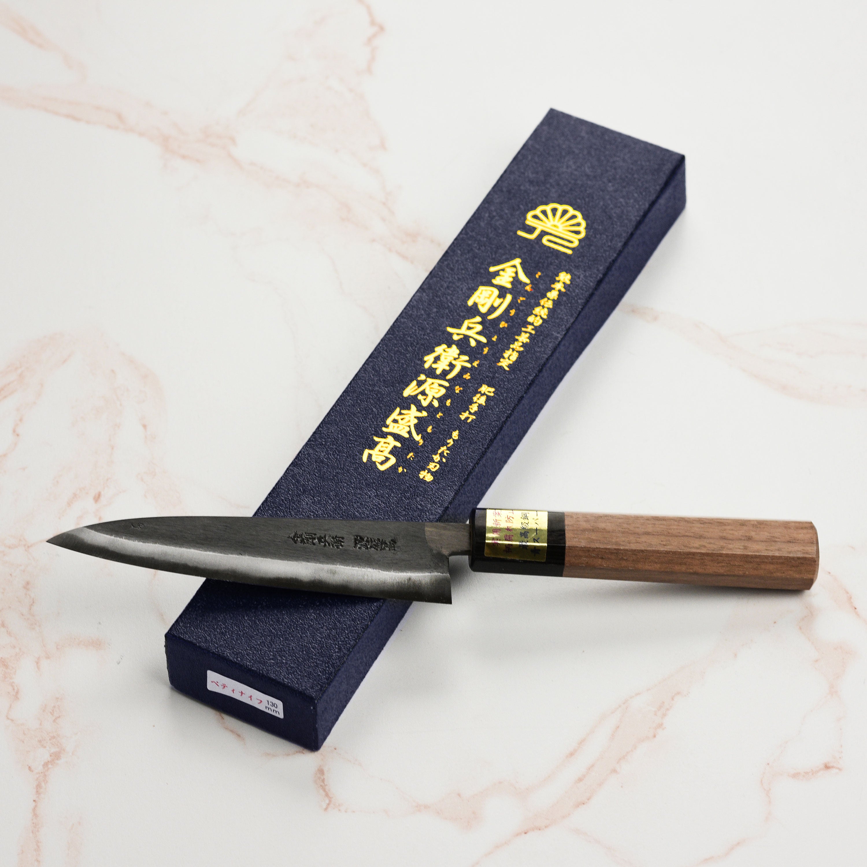 Close-up of the hand-forged blue steel blade and handle of the Moritaka petty knife