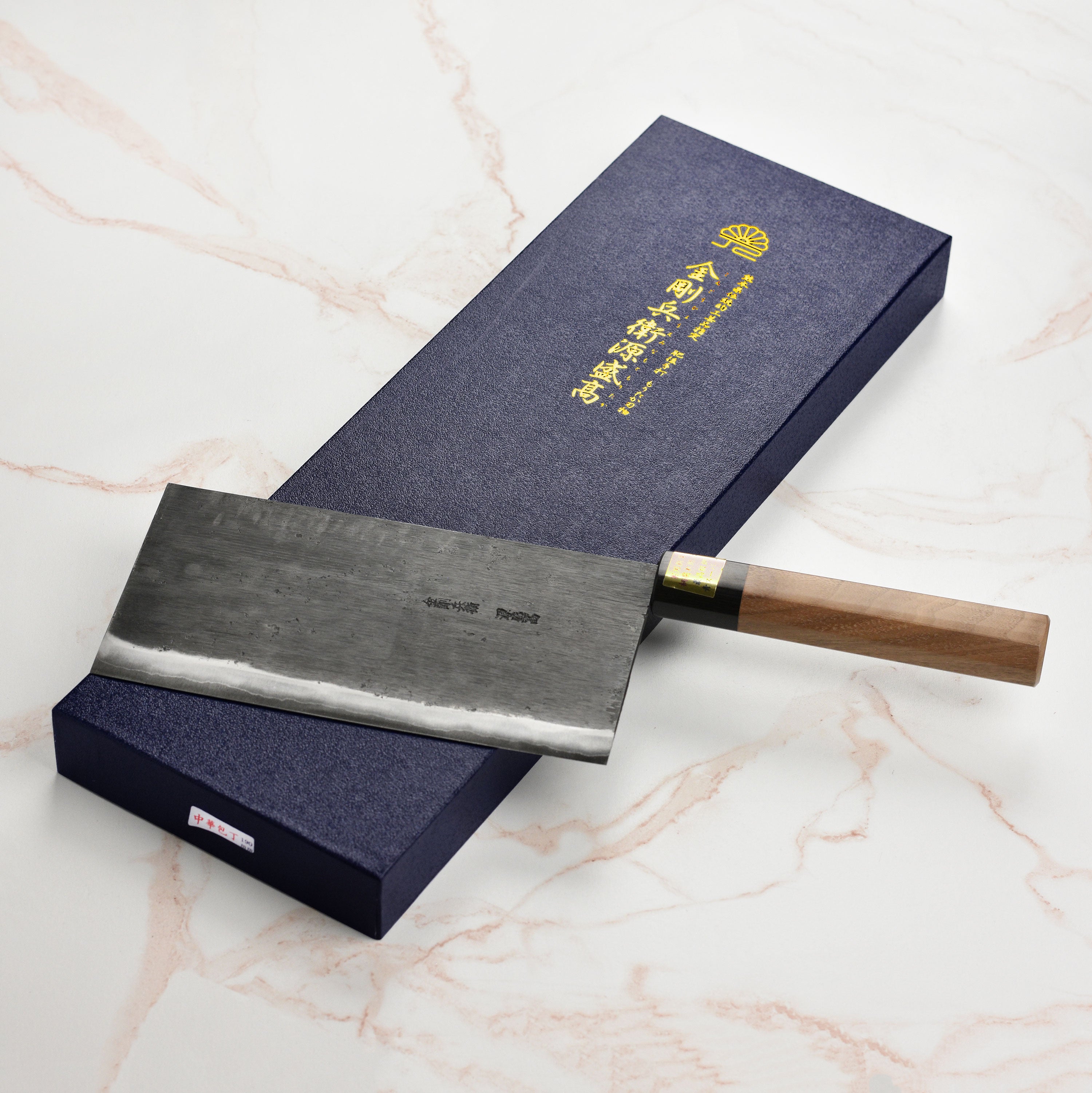 Japanese chef using Moritaka carbon steel knife for slicing vegetables in professional kitchen