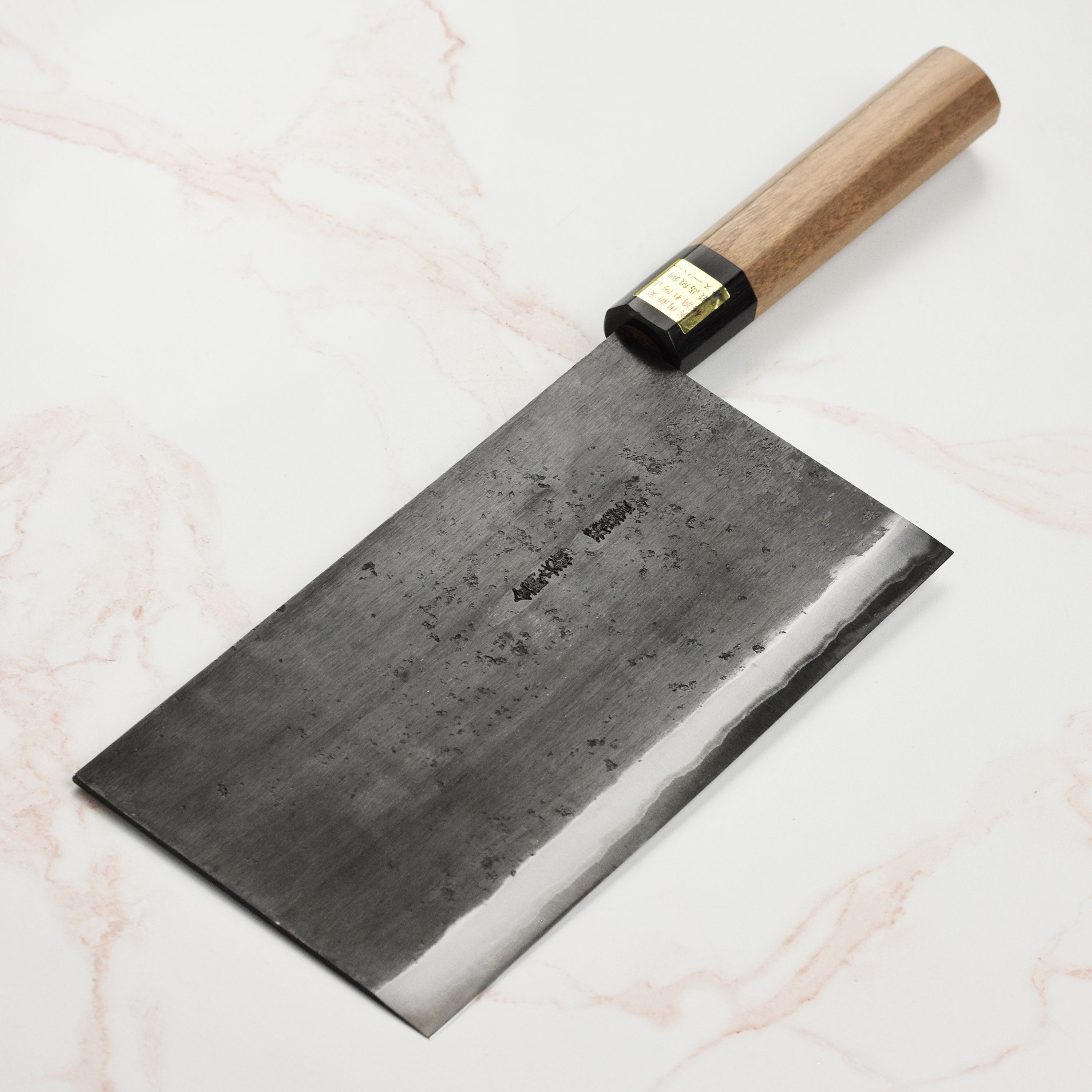 Close-up view of Moritaka Aogami Super Carbon Steel Chef's Knife showcasing the sharp blade and walnut handle.