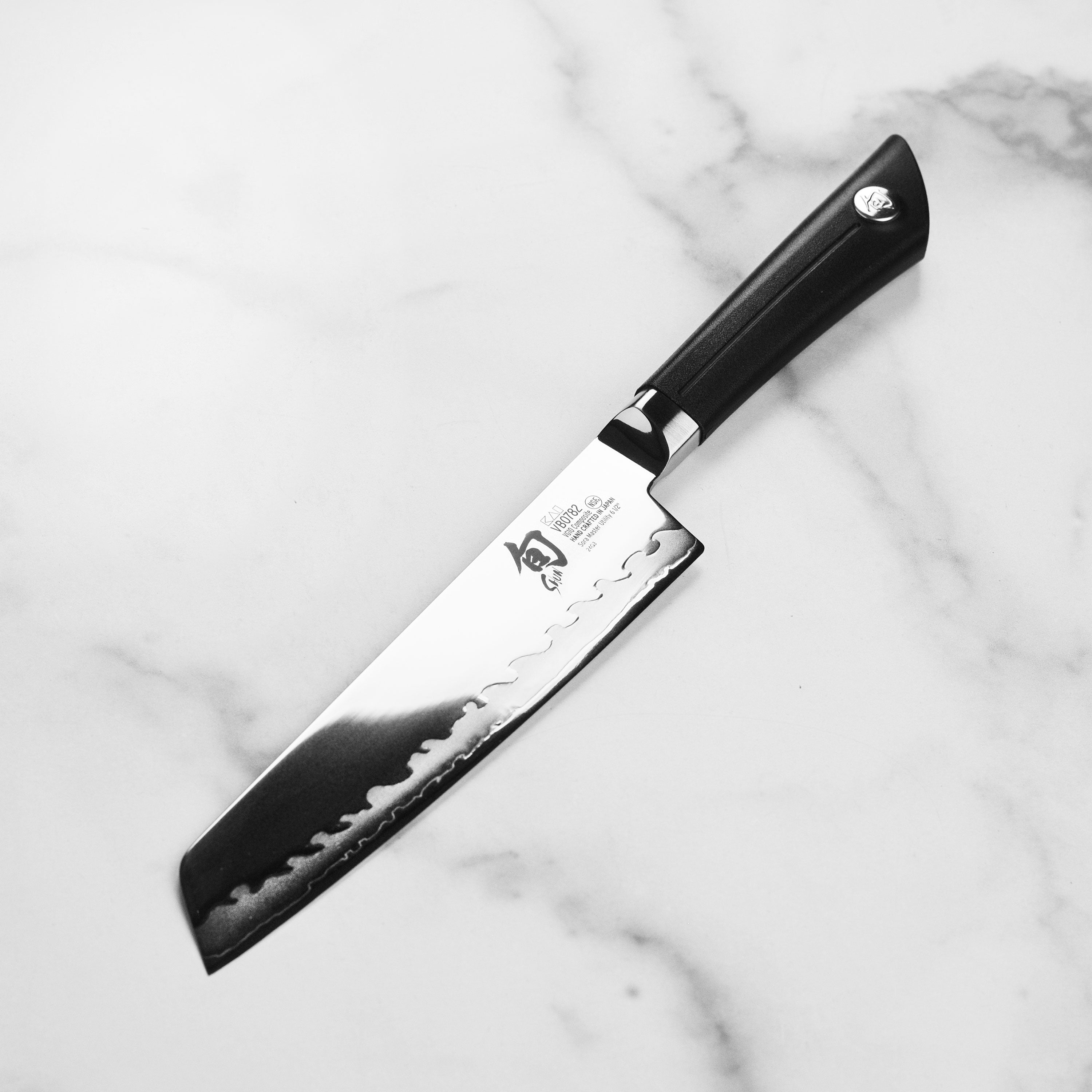 Elegant presentation of the Sora Master Japanese Utility Knife on a wooden cutting board.