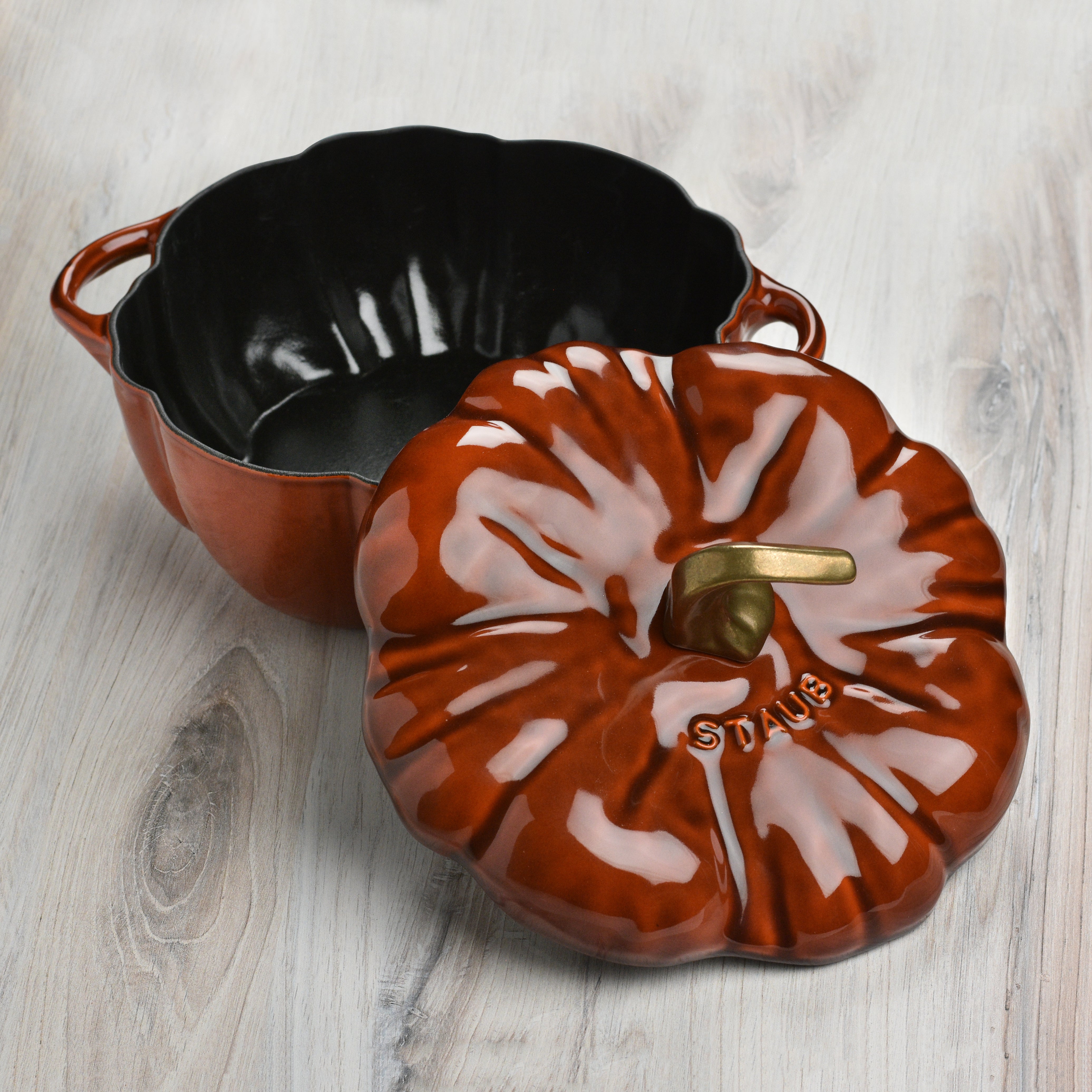 Side view of the cast iron cocotte on an induction stovetop, demonstrating its versatility.