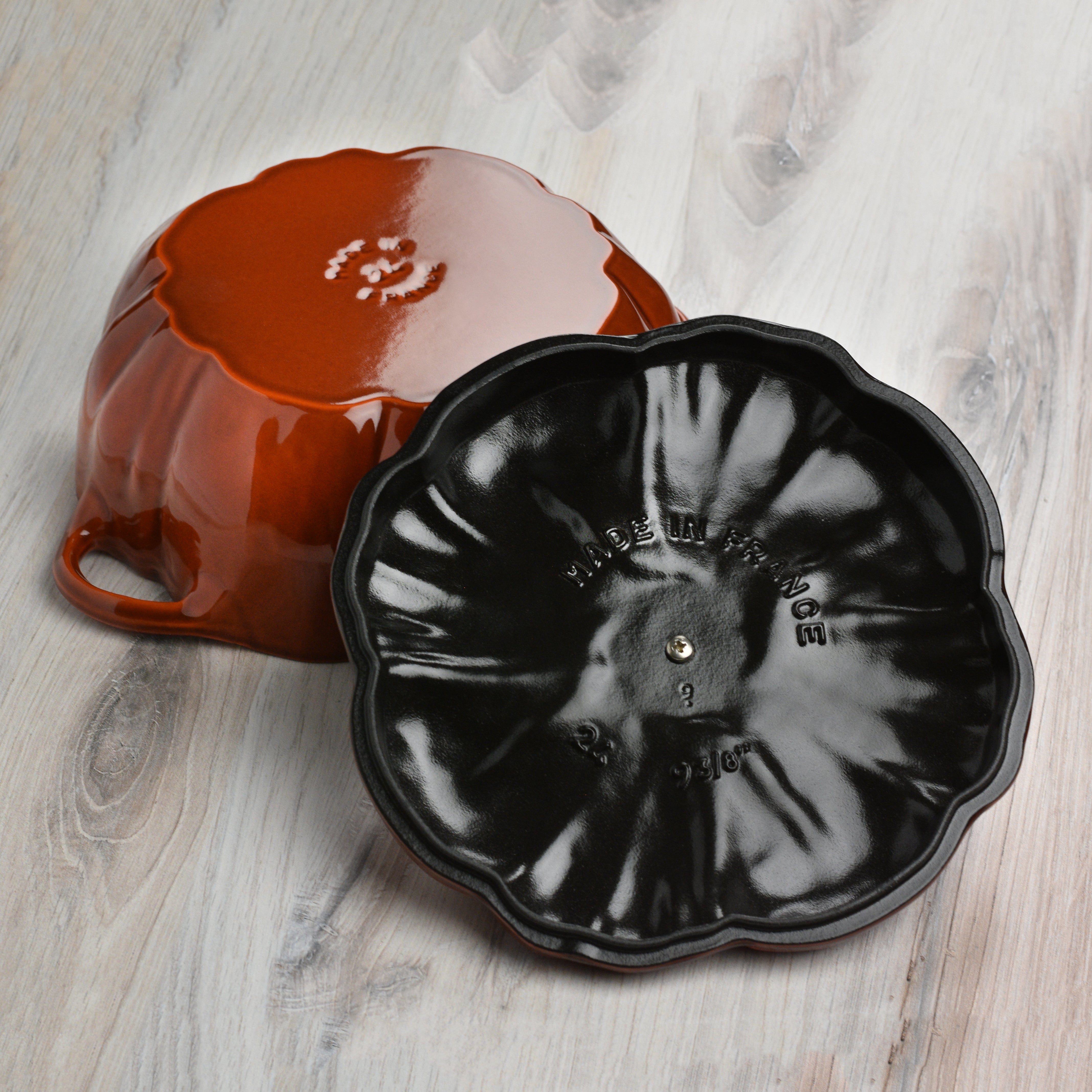 Side view of the cast iron cocotte on an induction stovetop, demonstrating its versatility.