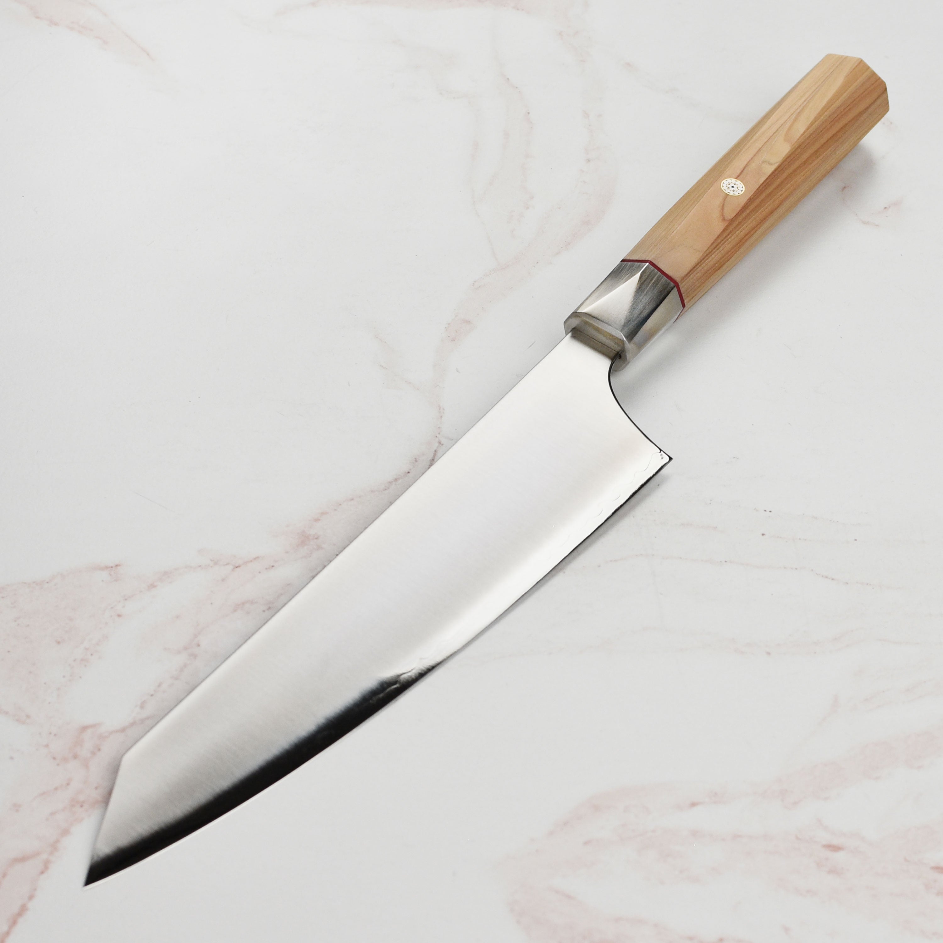 Elegant Hinoki wood handle with red spacer and mosaic pin on the gyuto knife.