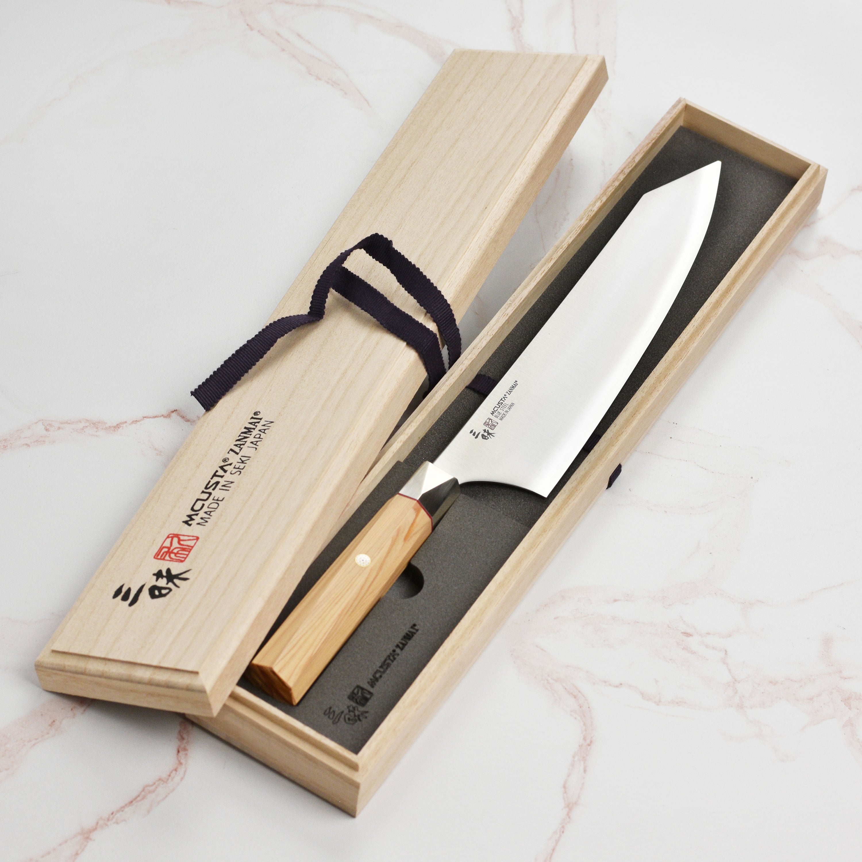 Side view of the Aogami Steel Master Gyuto knife demonstrating its sharp edge and elegant design.