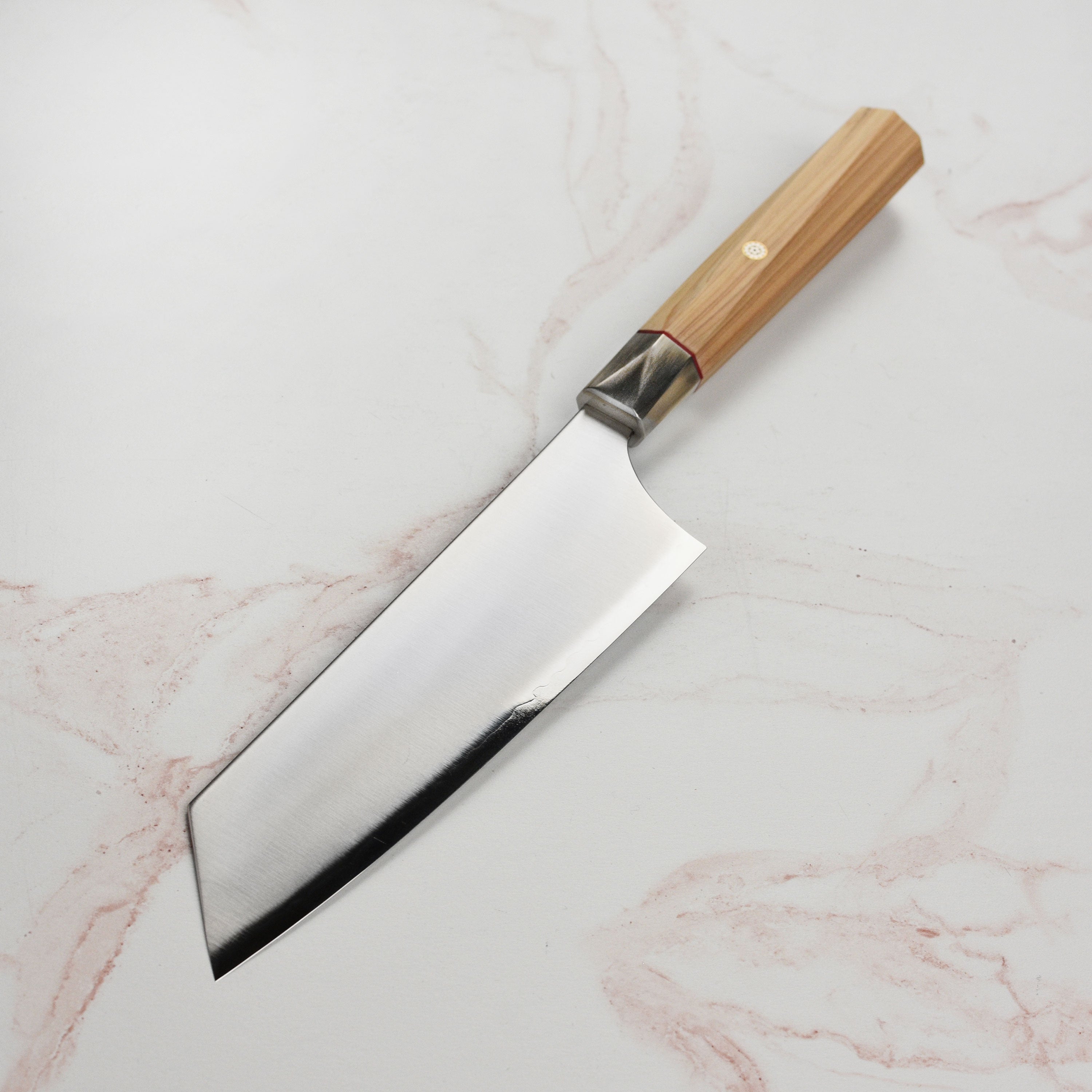 Top view of the handcrafted Japanese chef knife showing its double bevel edge