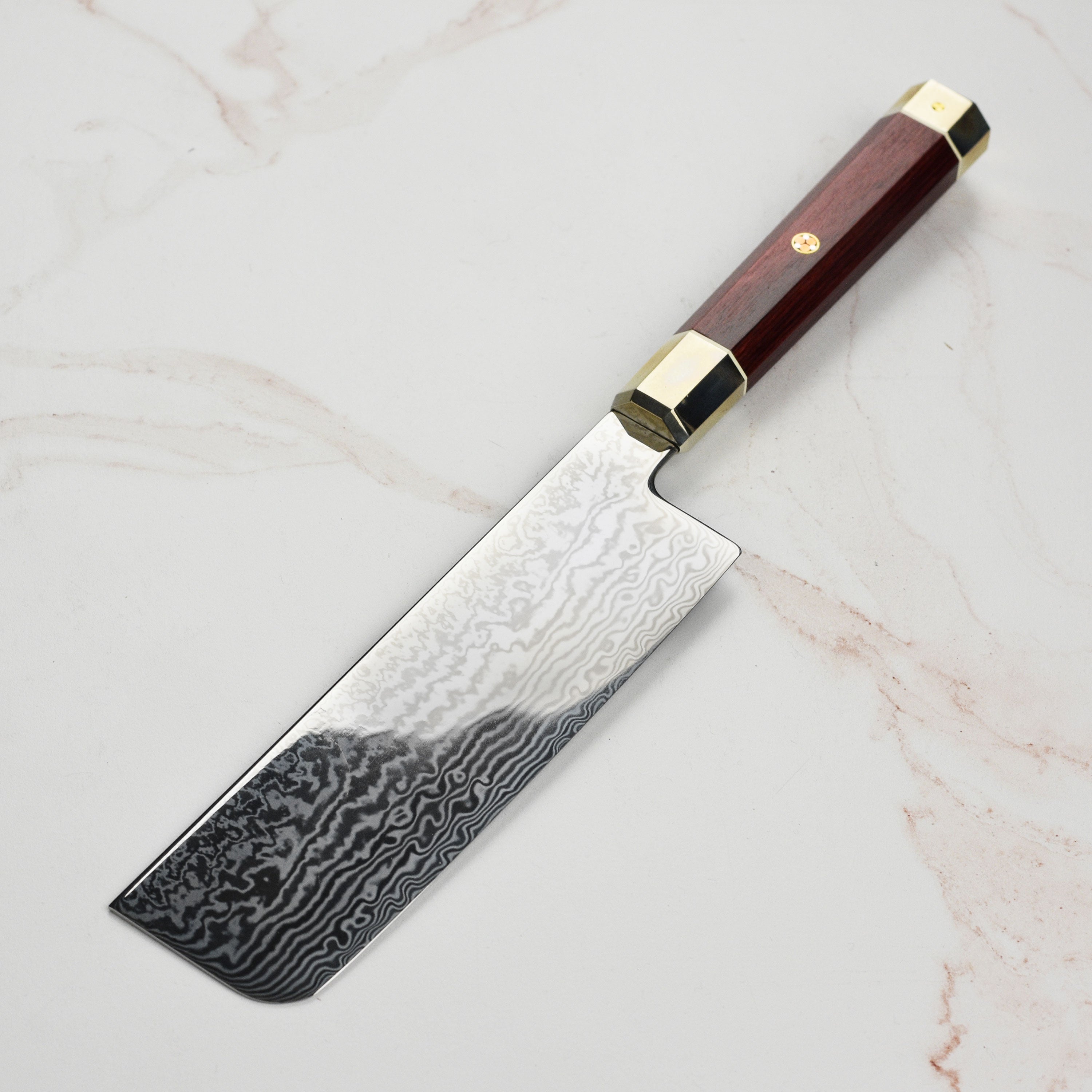 Elegant Japanese kitchen knife with red Pakkawood handle and nickel silver bolster