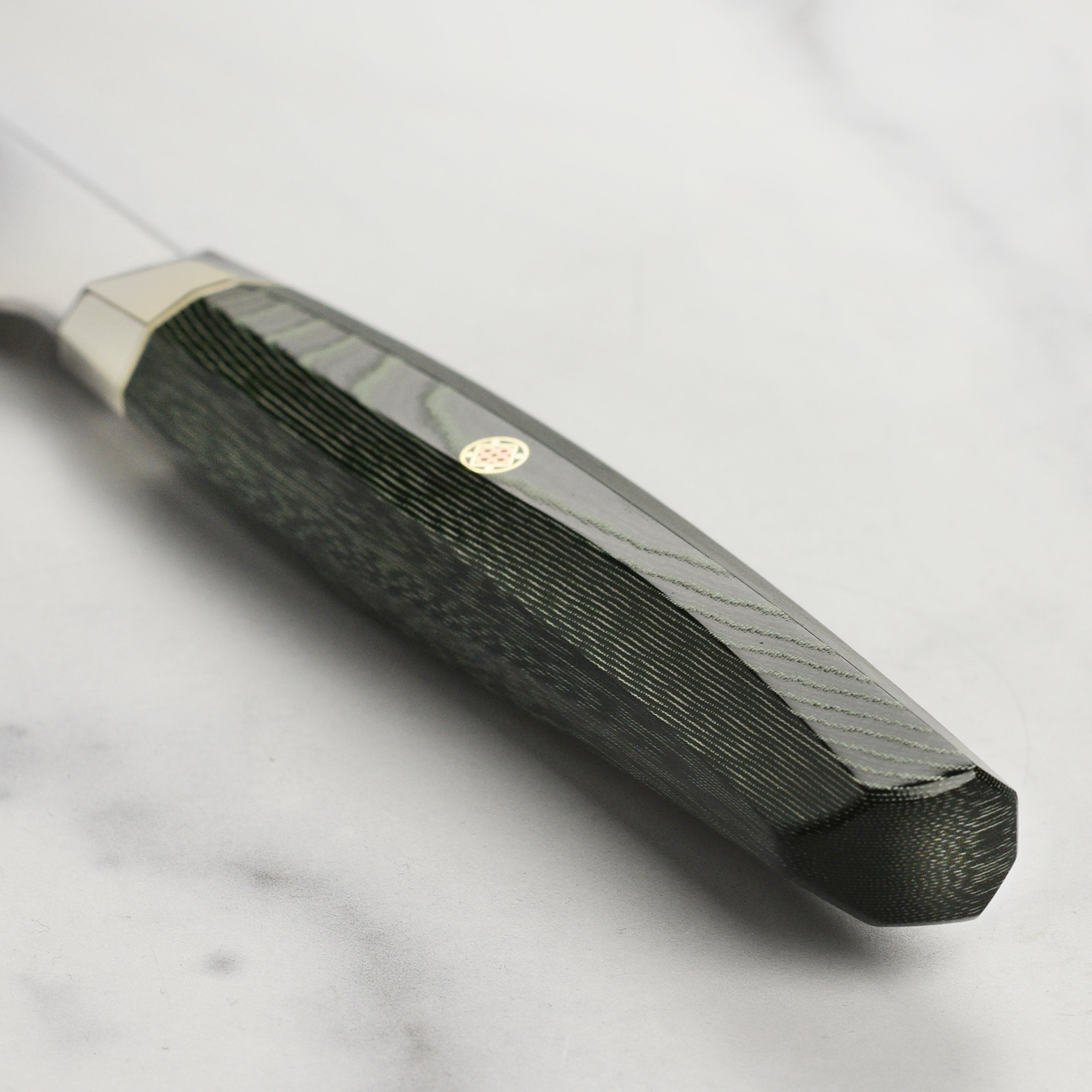 Close-up of the SG2 powder steel blade, highlighting its sharpness and craftsmanship.